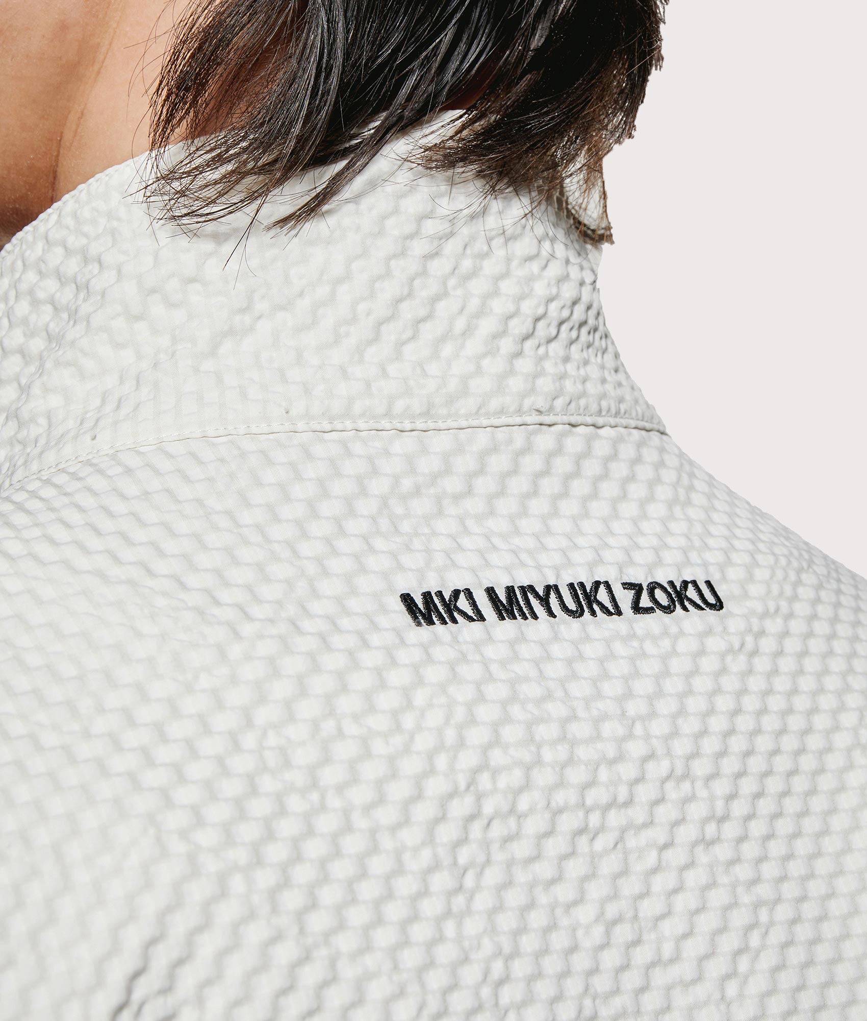 MKI MIYUKI ZOKU Seersucker Quarter Zip Sweatshirt in Bone at EQVVS Menswear. Detail shot.