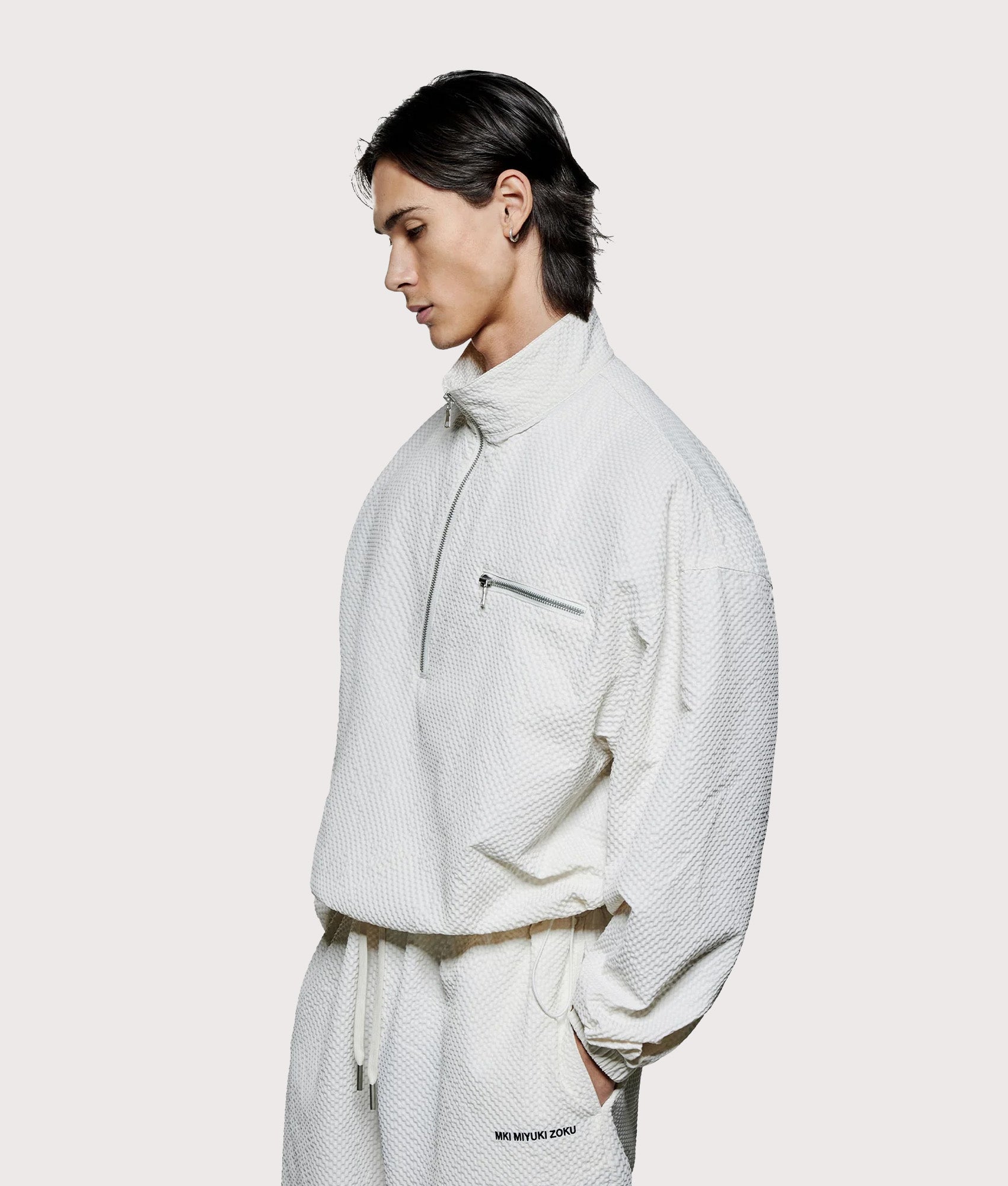 MKI MIYUKI ZOKU Seersucker Quarter Zip Sweatshirt in Bone at EQVVS Menswear. Angled model front shot.