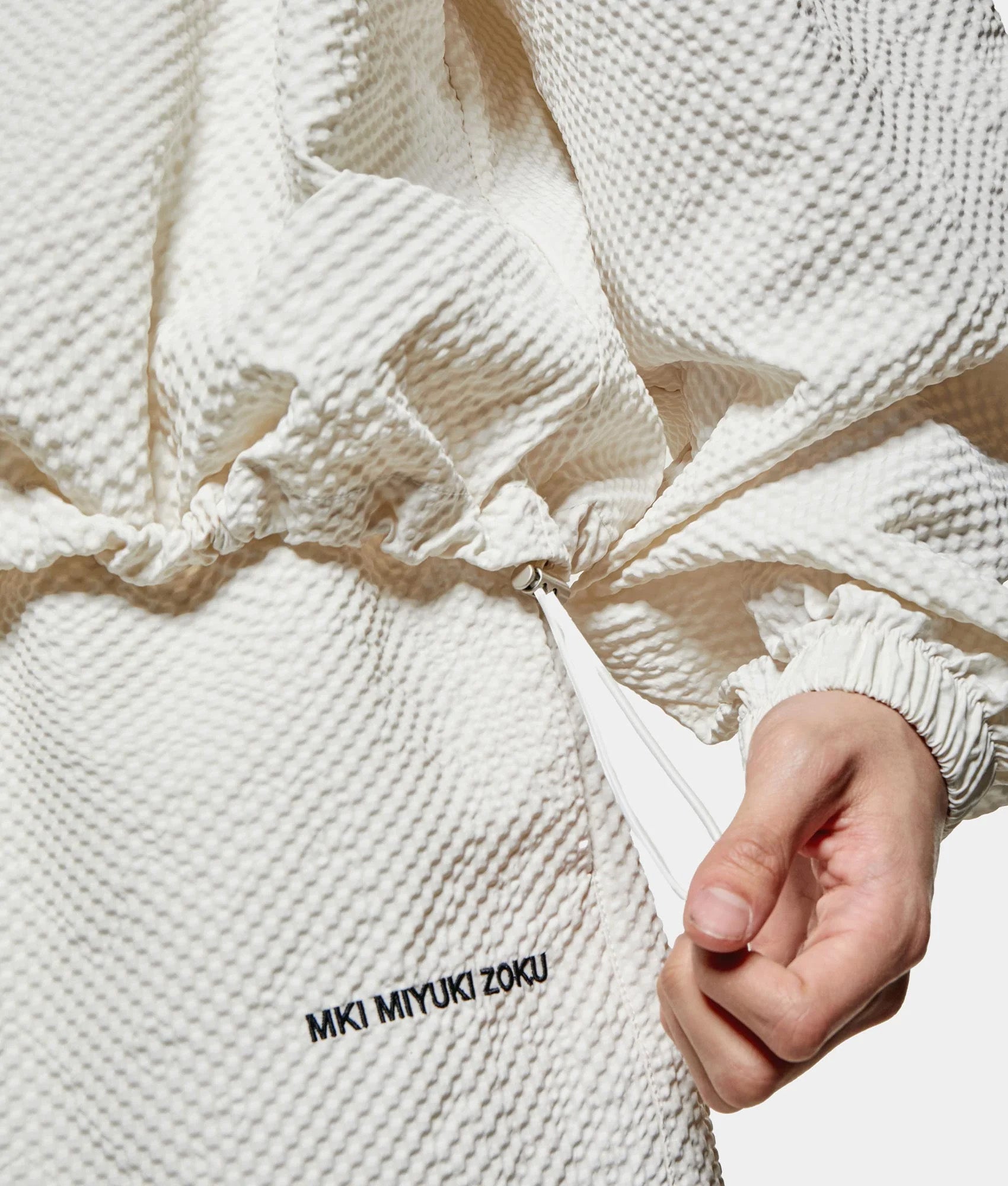 MKI MIYUKI ZOKU Seersucker Quarter Zip Sweatshirt in Bone at EQVVS Menswear. Side shot.