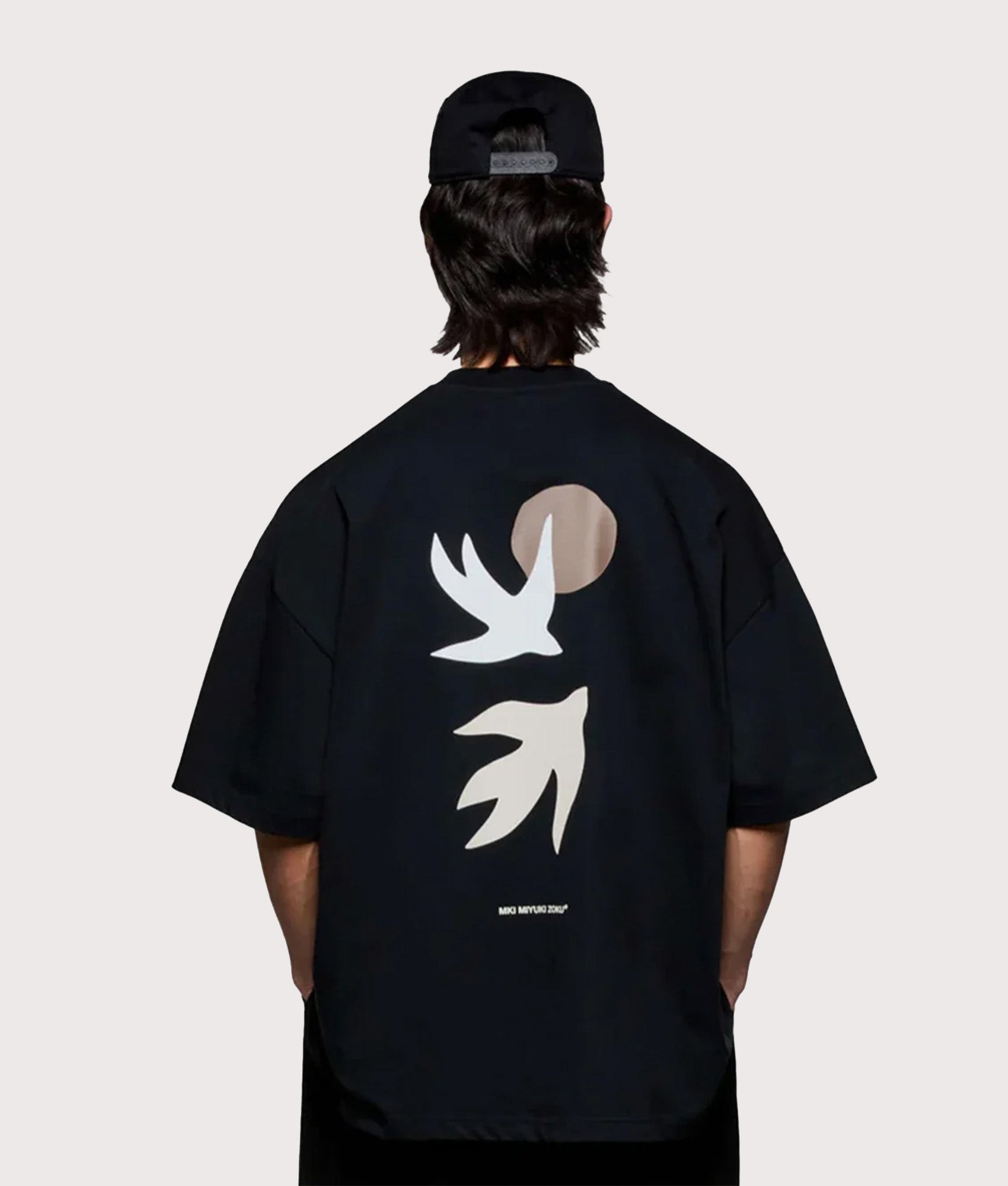 MKI MIYUKI ZOKU Oversized Swallow T-Shirt in Black at EQVVS Menswear. Model back shot.