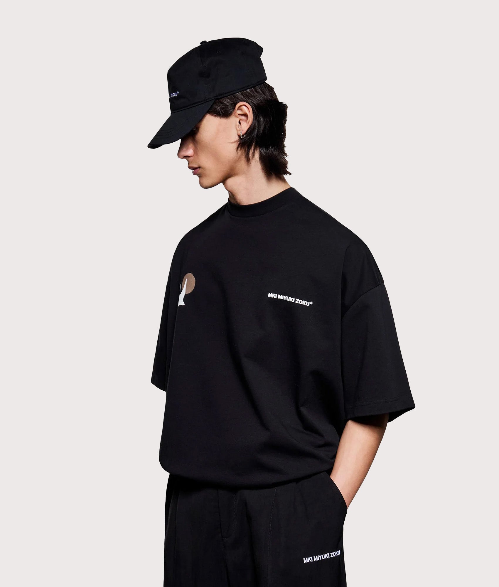 MKI MIYUKI ZOKU Oversized Swallow T-Shirt in Black at EQVVS Menswear. Angled model front shot.