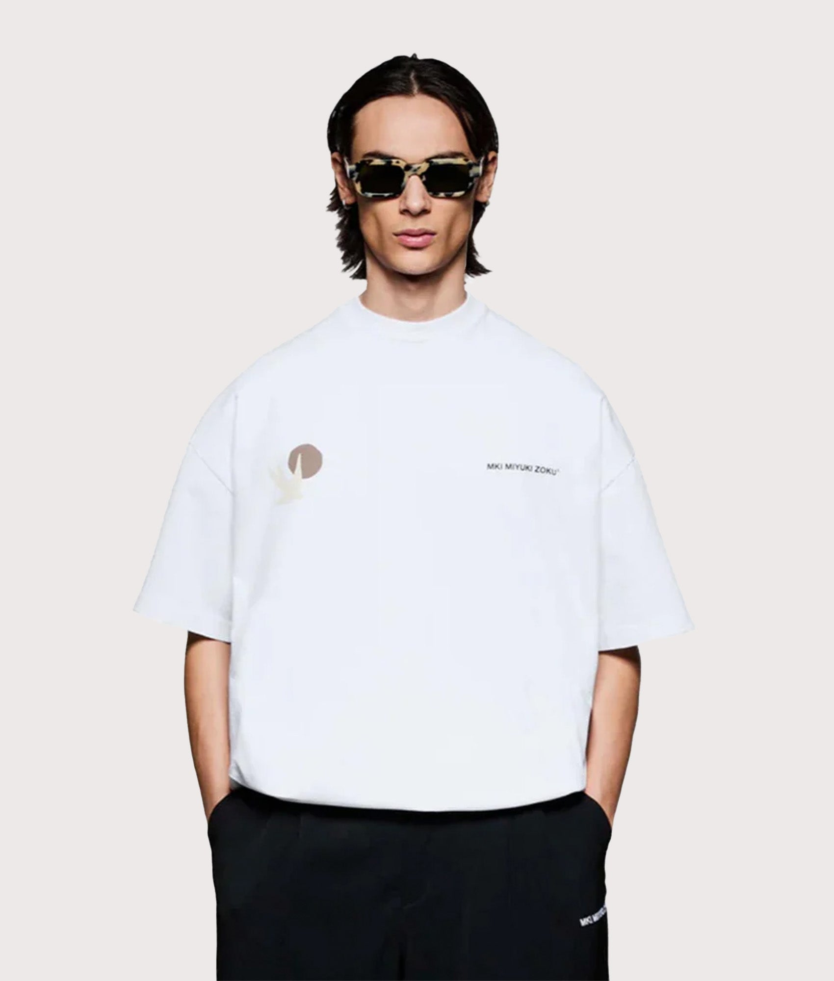 MKI MIYUKI ZOKU Oversized Swallow T-Shirt in White at EQVVS Menswear. Model front shot.