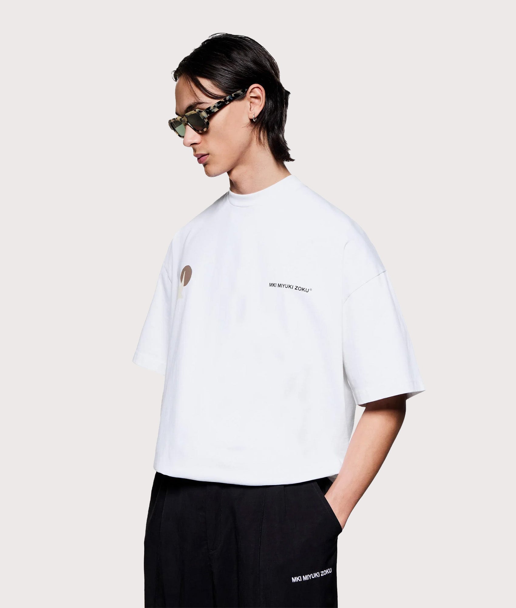 MKI MIYUKI ZOKU Oversized Swallow T-Shirt in White at EQVVS Menswear. Angled model front shot.