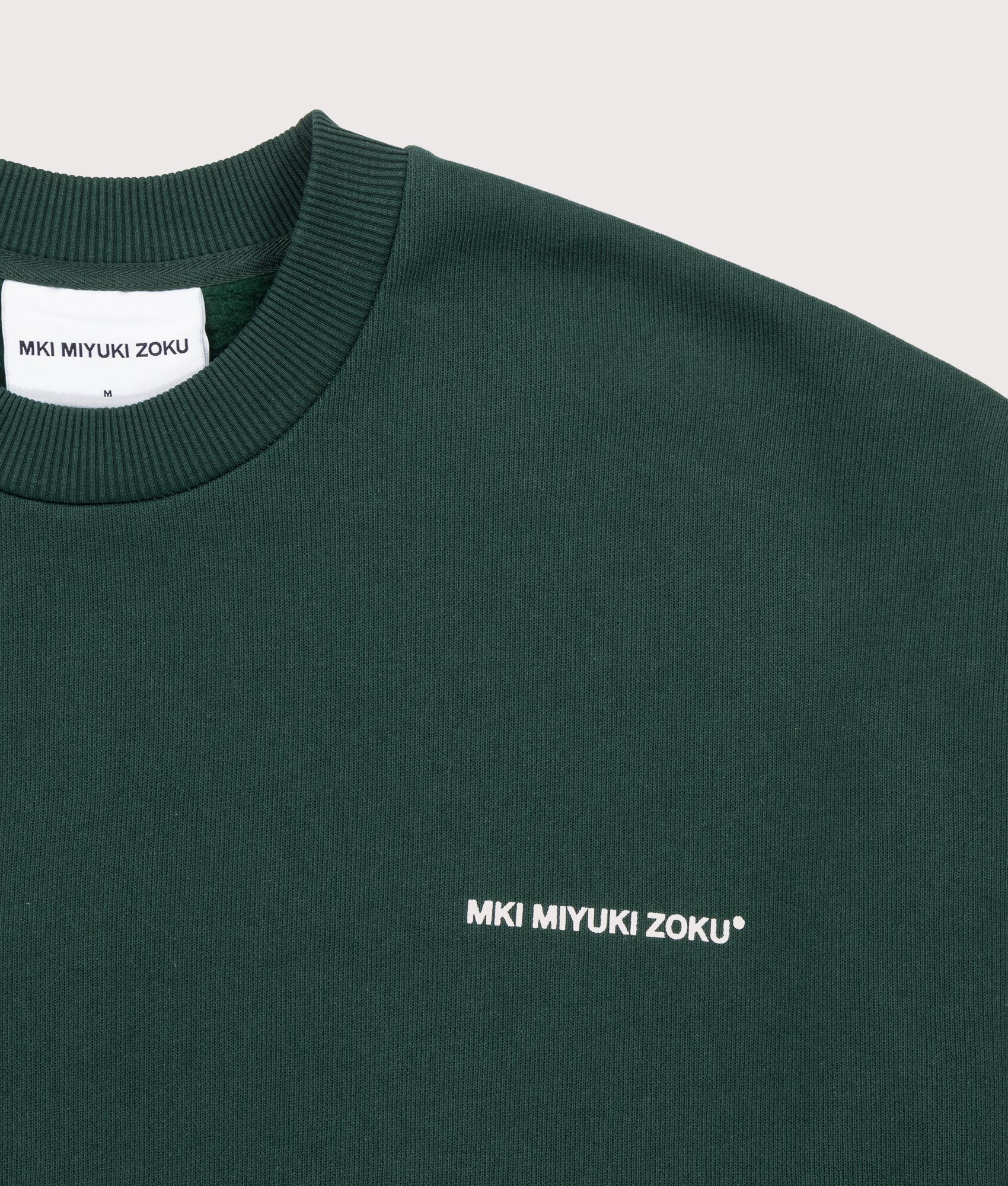 MKI MIYUKI ZOKU Oversized Uniform Crewneck Sweatshirt in Green at EQVVS Menswear. Detail shot.