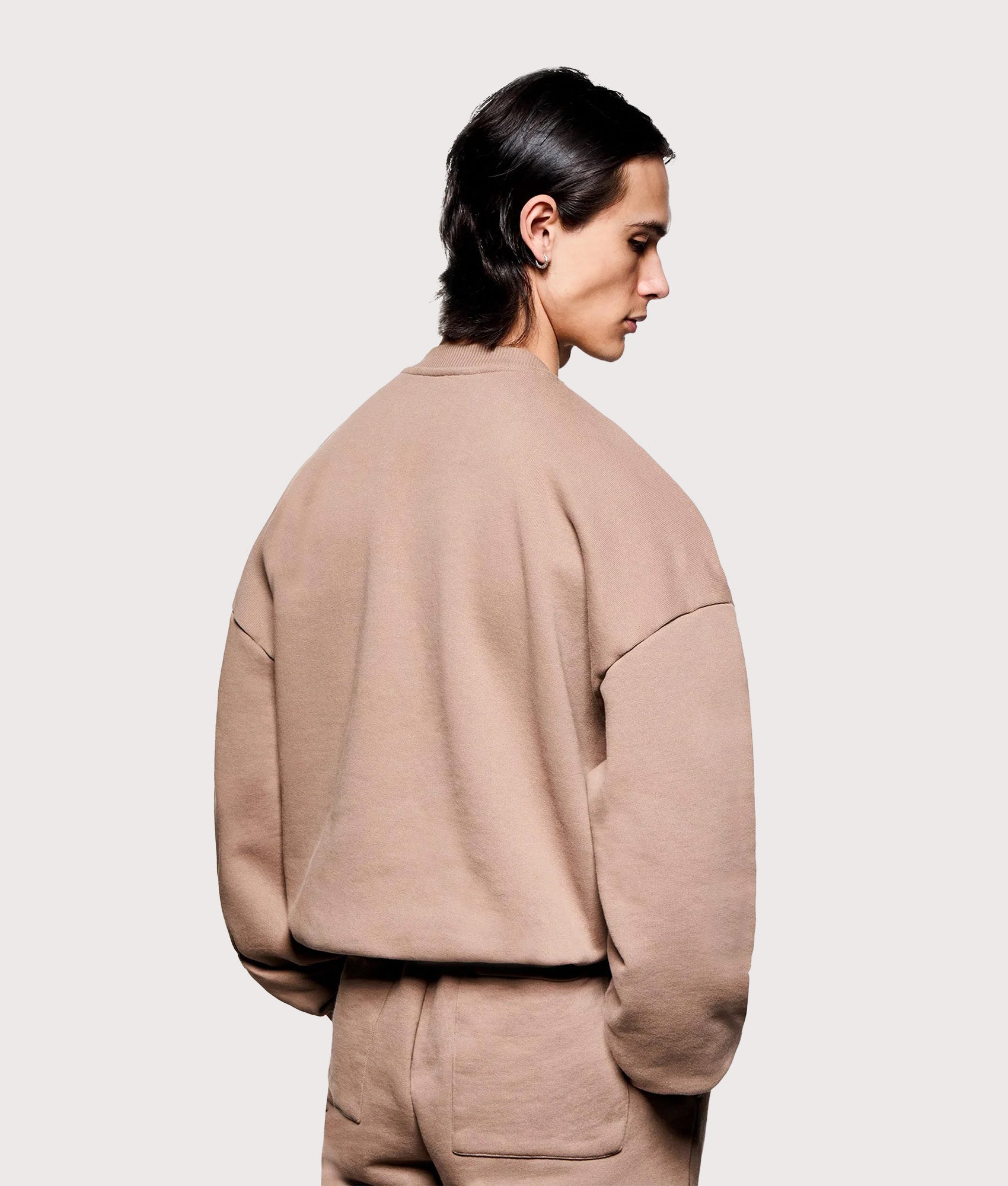 MKI MIYUKI ZOKU Overshirt Uniform Crewneck Sweatshirt in Mushroom at EQVVS Menswear. Angled model back shot.