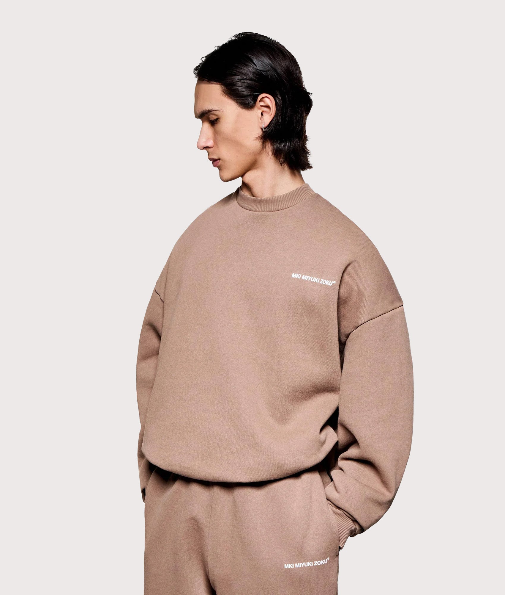 MKI MIYUKI ZOKU Overshirt Uniform Crewneck Sweatshirt in Mushroom at EQVVS Menswear. Angled model front shot.