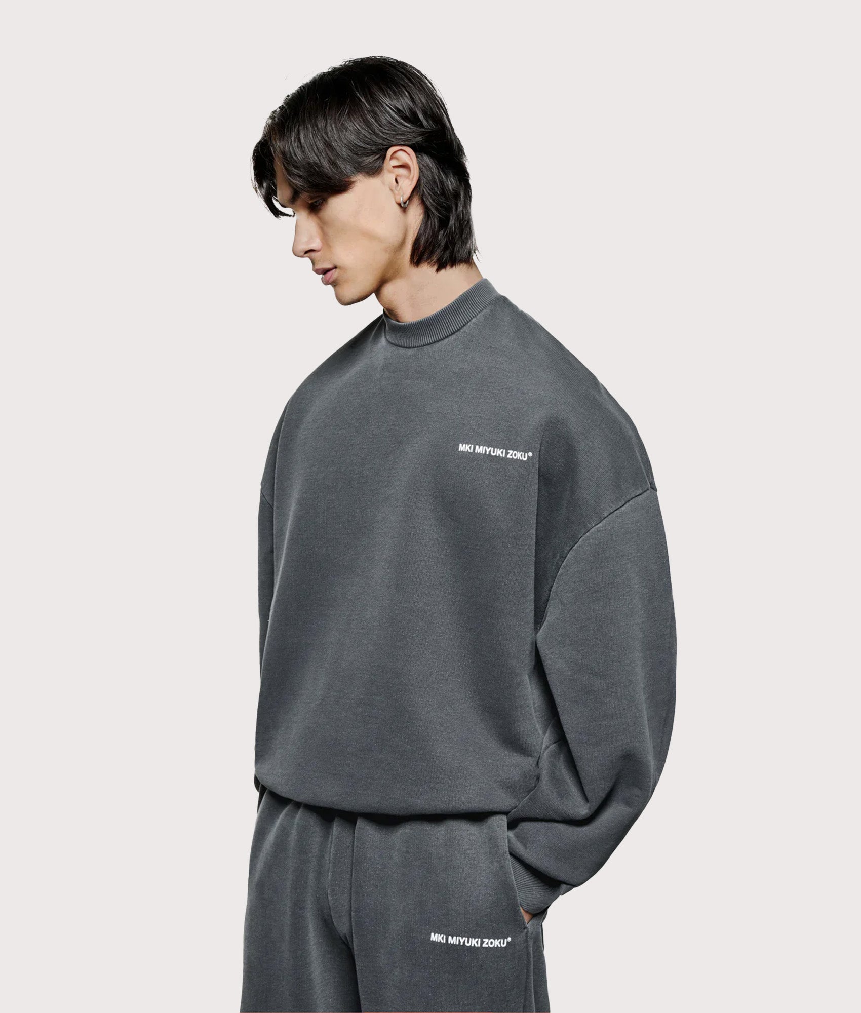 MKI Miyuki Zoku oversized Uniform Crew Sweatshirt in Pigment Black at EQVVS Menswear. Angled model front shot.