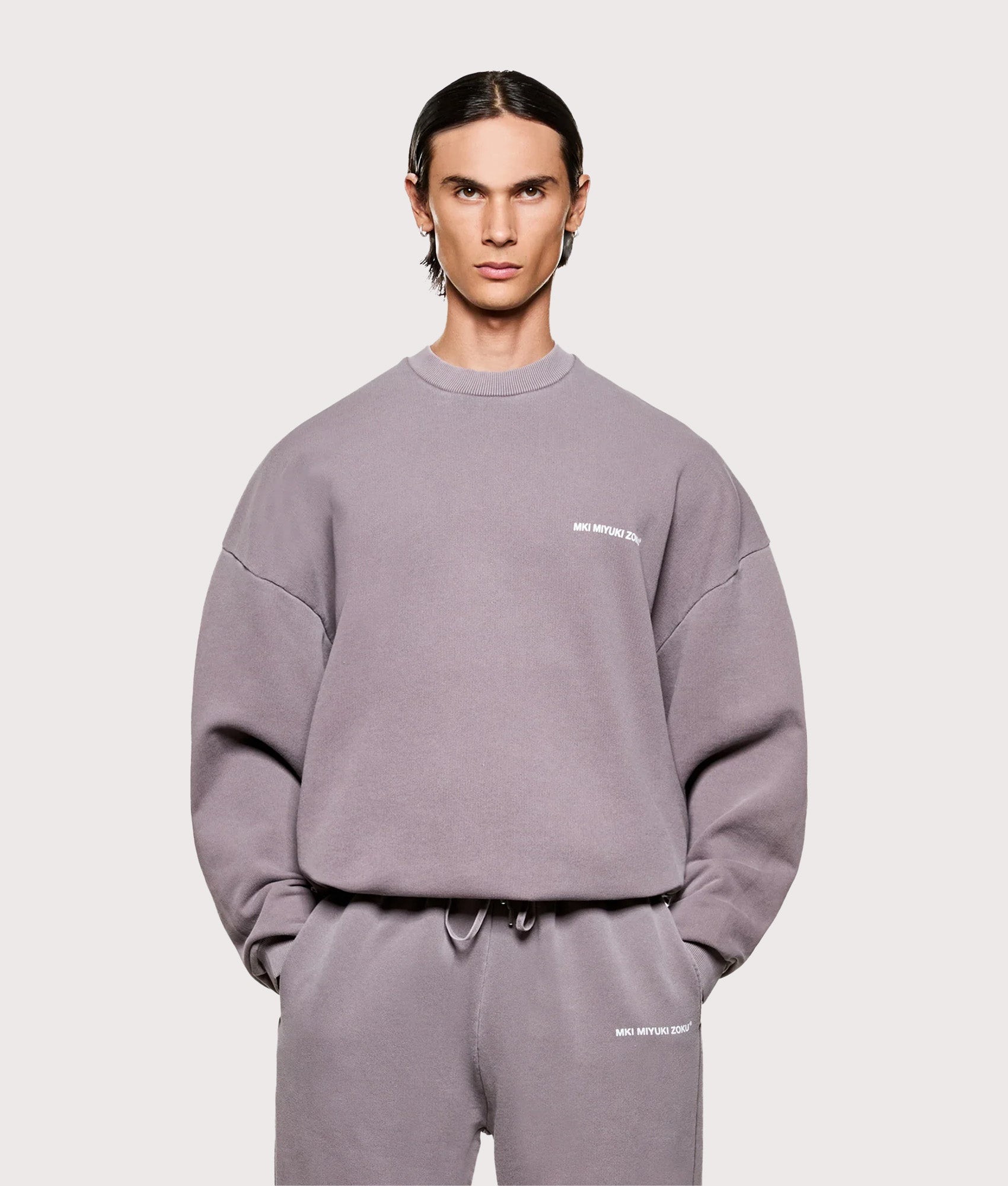 MKI MIYUKI ZOKU Oversized Uniform Crewneck Sweatshirt in Pigment Raisin at EQVVS Menswear. Model front shot.