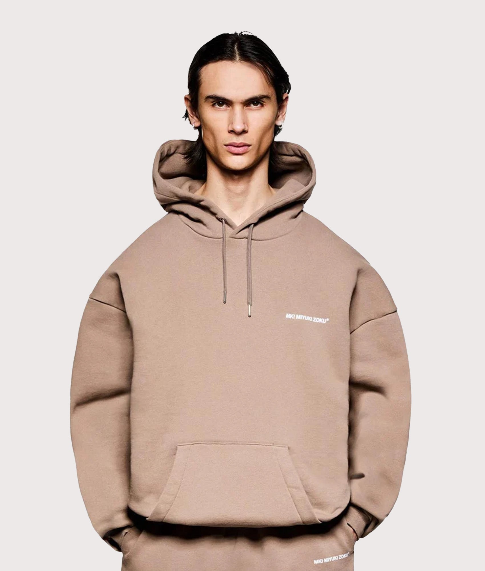 MKI MIYUKI ZOKU Oversized Uniform Hoodie in Mushroom at EQVVS Menswear. Model front shot.