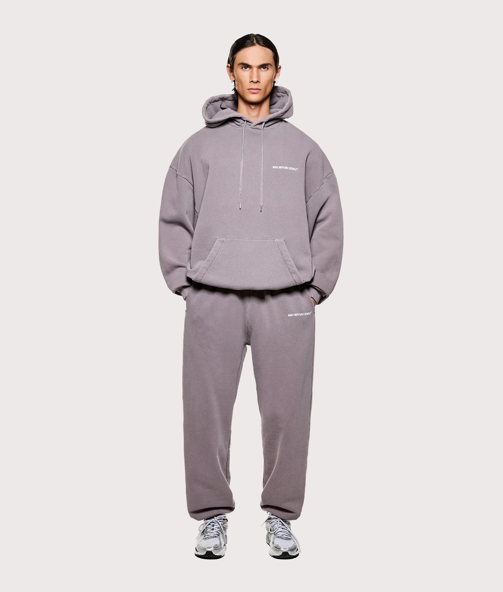 MKI MIYUKI ZOKU Uniform Hoodie in Pigment Raisin at EQVVS Menswear. Model full front. 