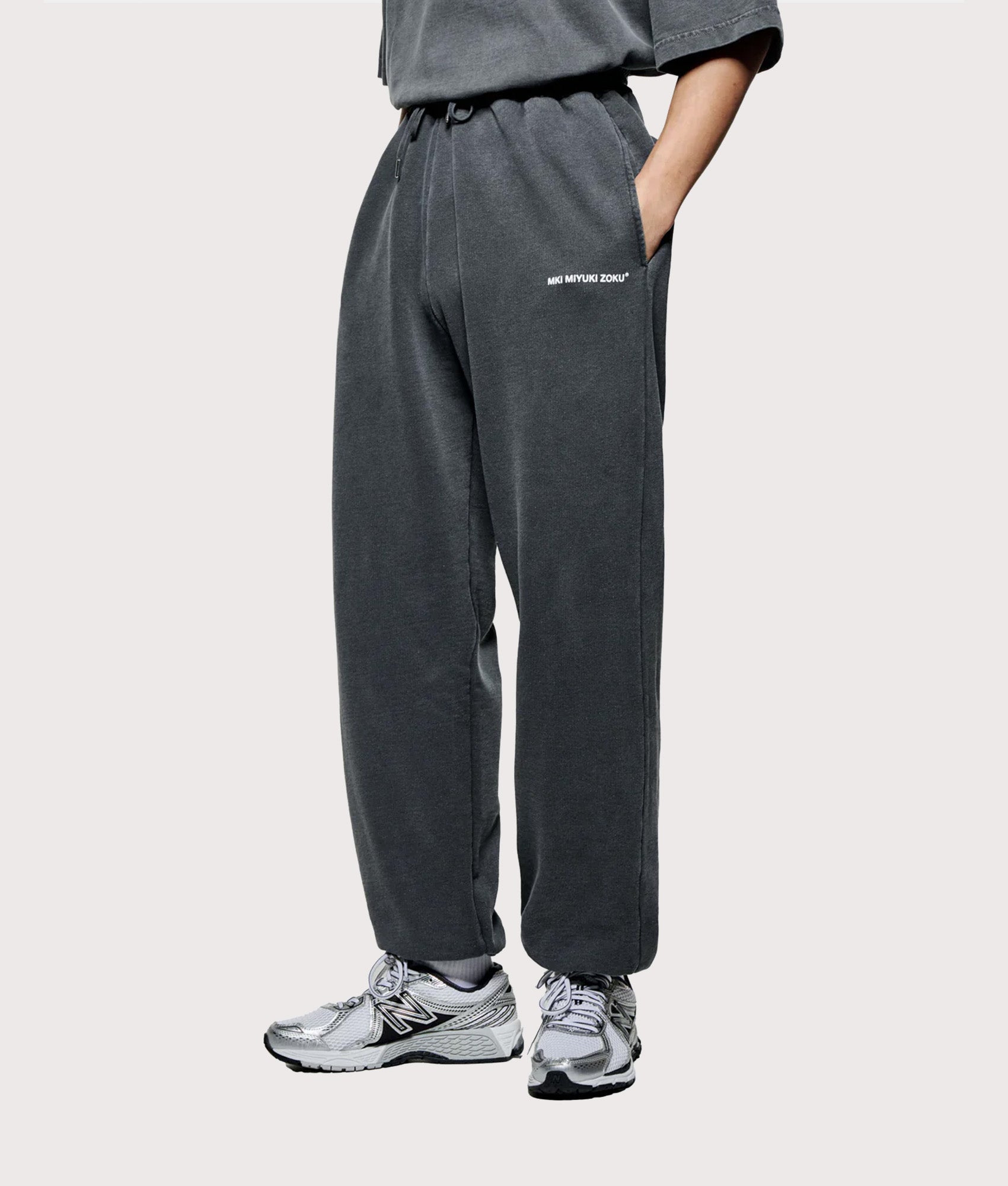 MKI Miyuki Zoku Uniform Joggers in PIgment Black at EQVVS Menswear. Angled model front shot.