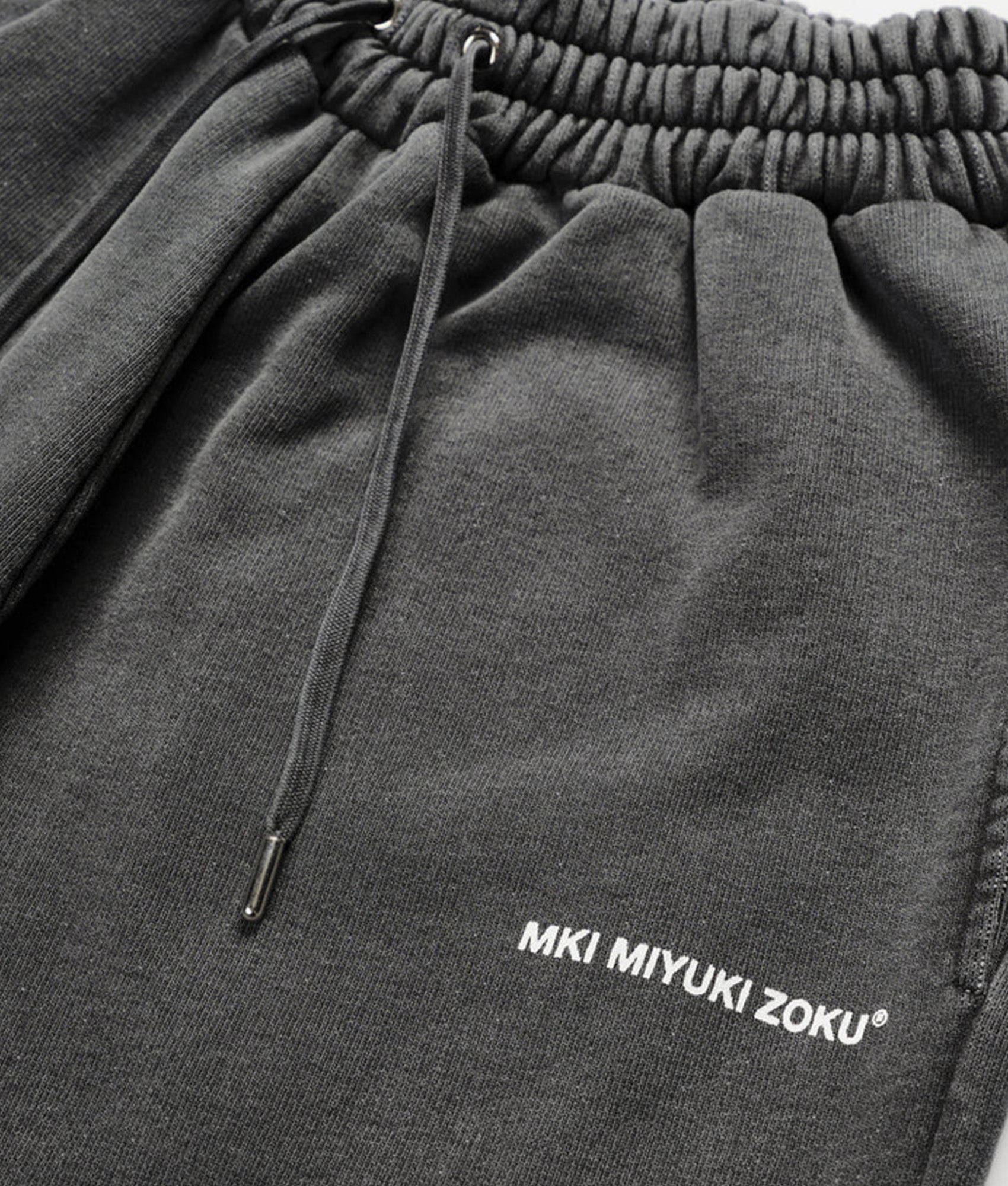 MKI Miyuki Zoku Uniform Joggers in PIgment Black at EQVVS Menswear. Detail shot.