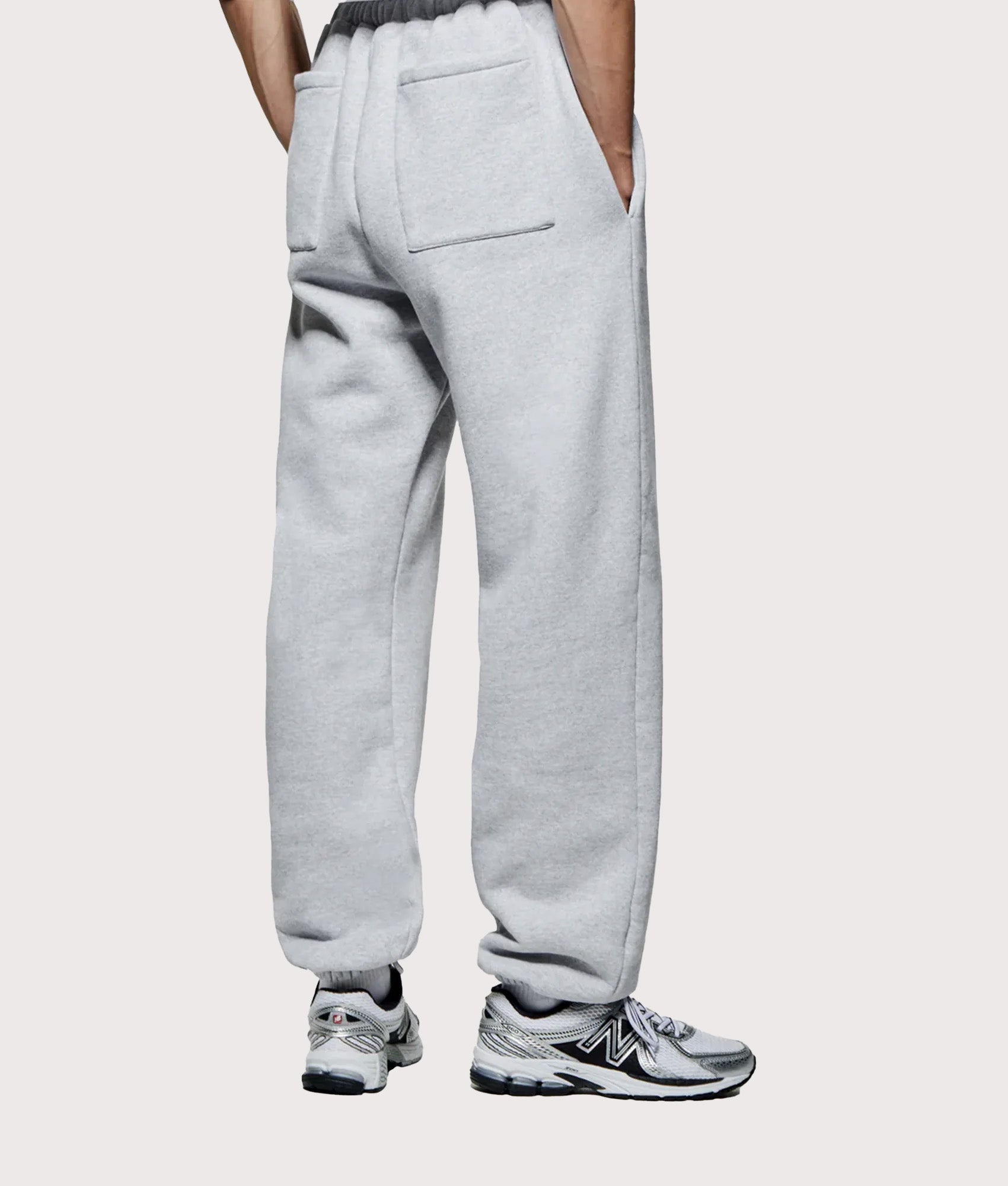 MKI MIYUKI ZOKU Uniform Joggers in Grey at EQVVS Menswear. Angled model back shot.