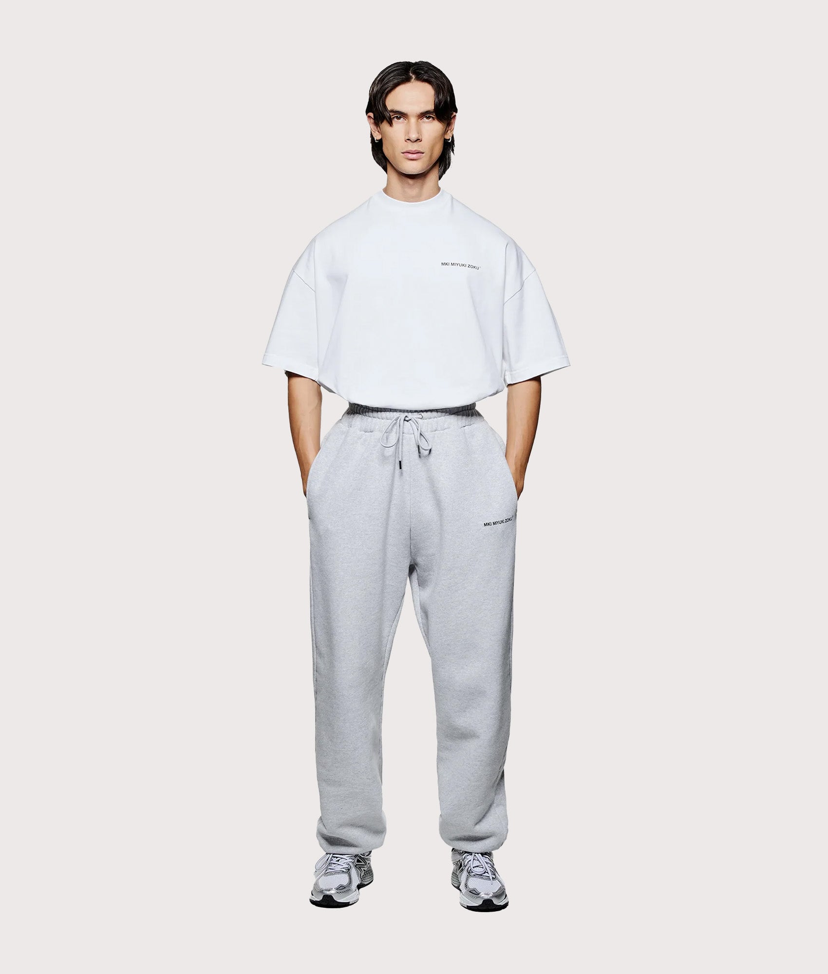 MKI MIYUKI ZOKU Uniform Joggers in Grey at EQVVS Menswear. Model full front shot.