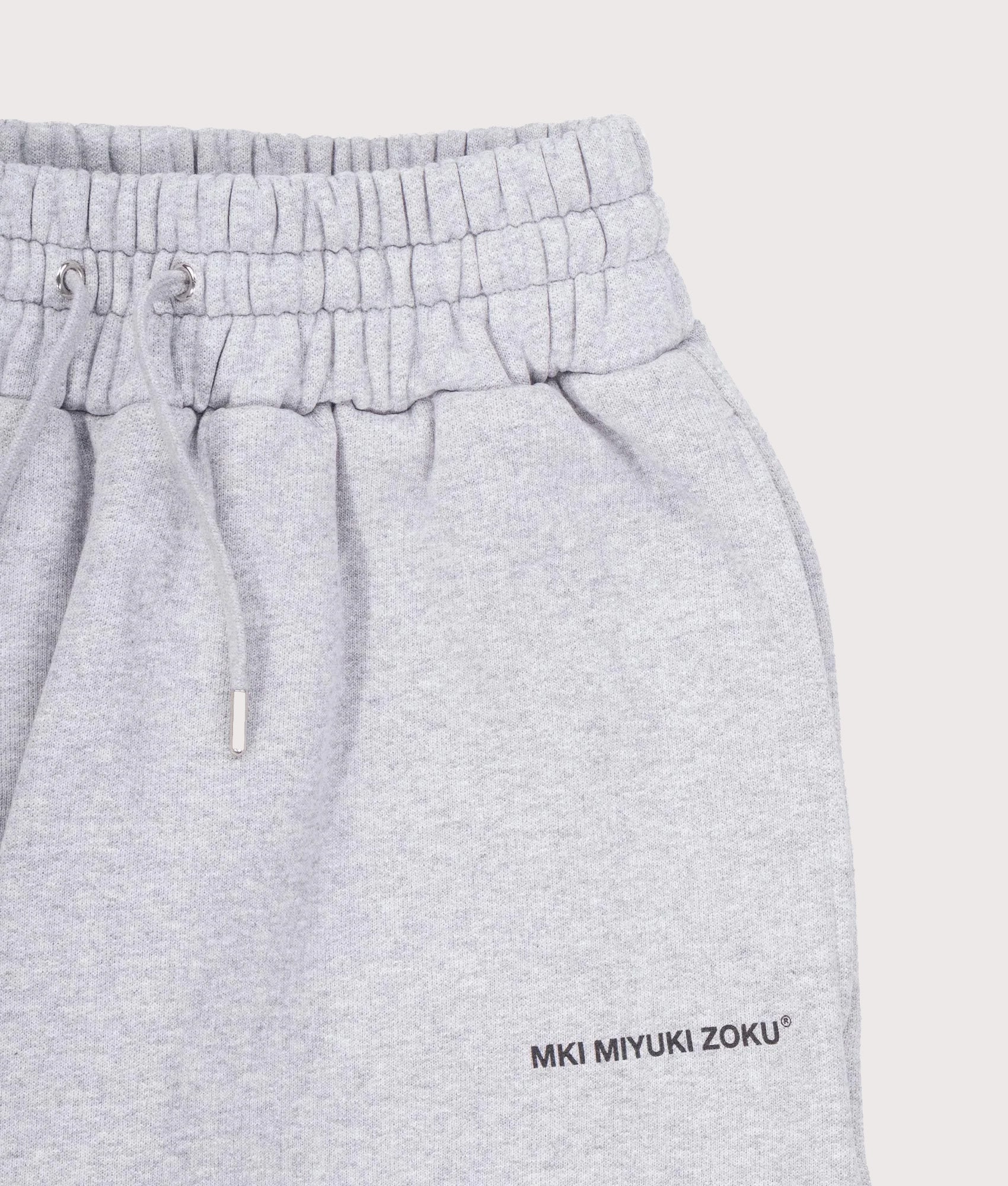 MKI MIYUKI ZOKU Uniform Joggers in Grey at EQVVS Menswear. Detail shot.