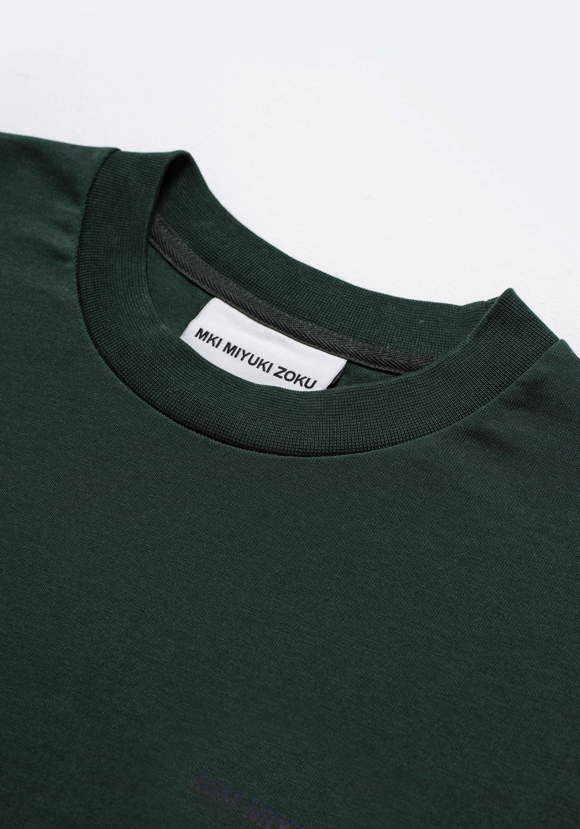 MKI Miyuki Zoku Long Sleeve Uniform T-Shirt in Green. Shot at EQVVS.  Detail shot. 
