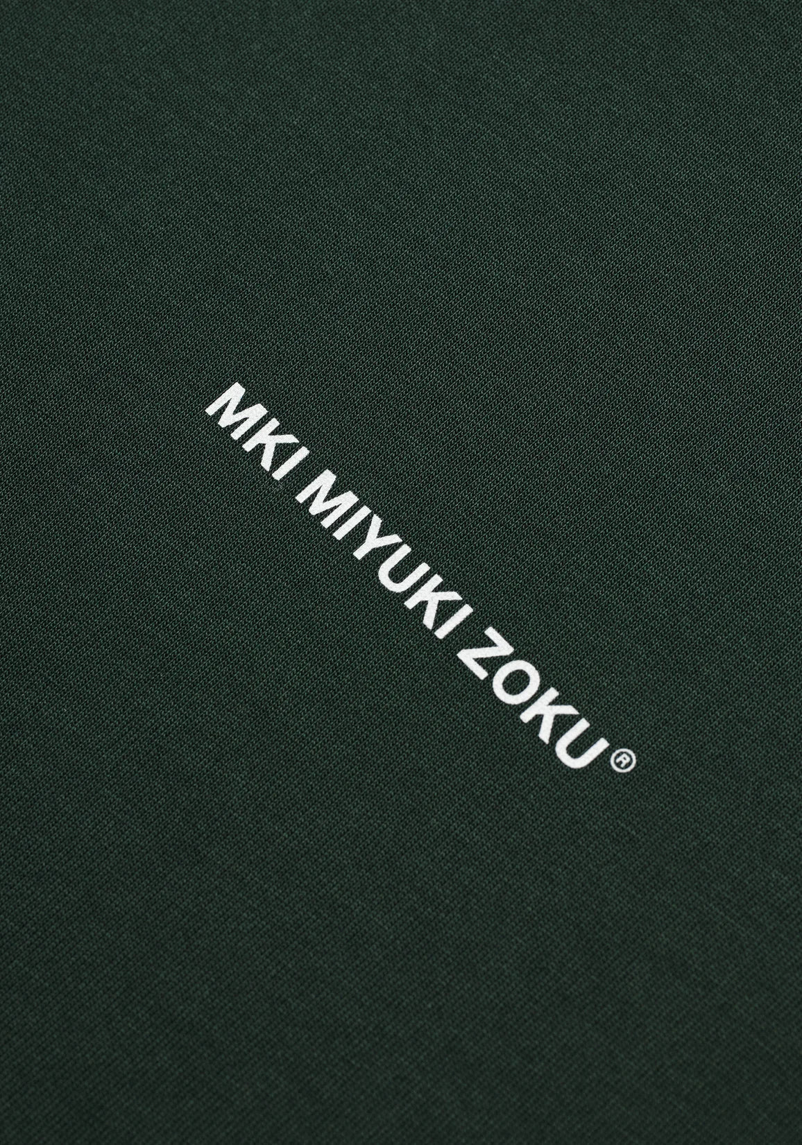 MKI Miyuki Zoku Long Sleeve Uniform T-Shirt in Green. Shot at EQVVS. Detail shot. 