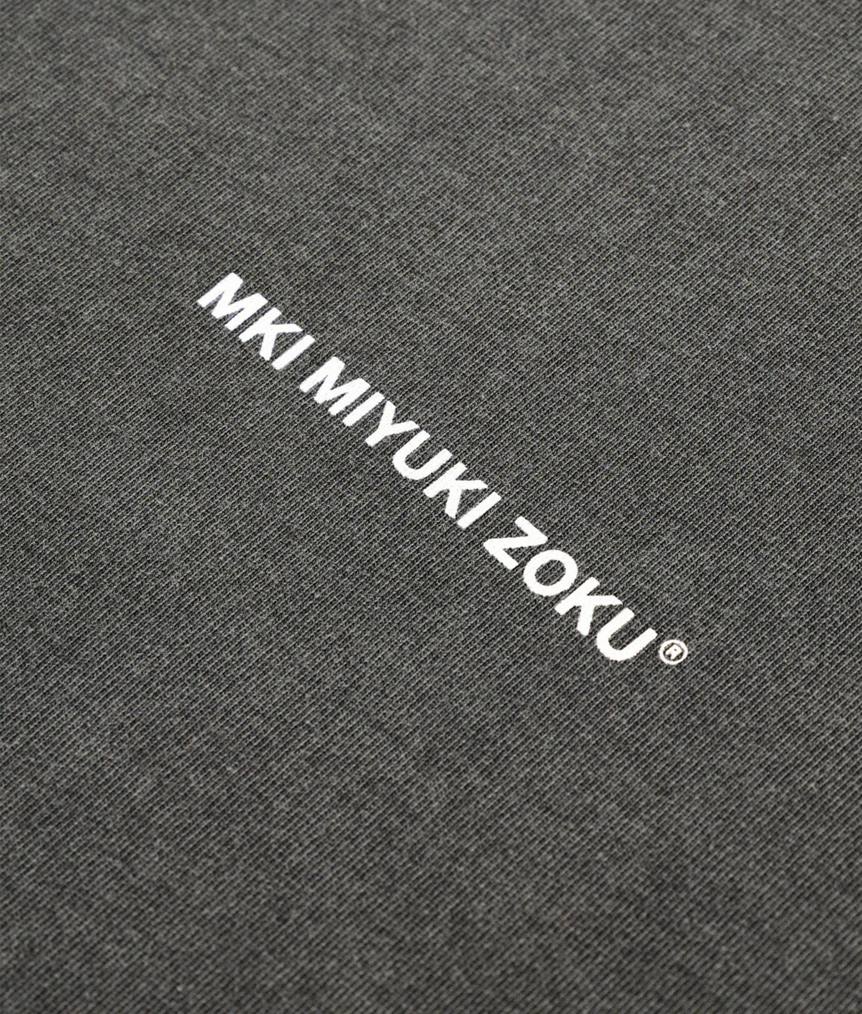 MKI Miyuki Zoku Long Sleeve Uniform T-Shirt in Pigment Black at EQVVS Menswear. Detail shot.