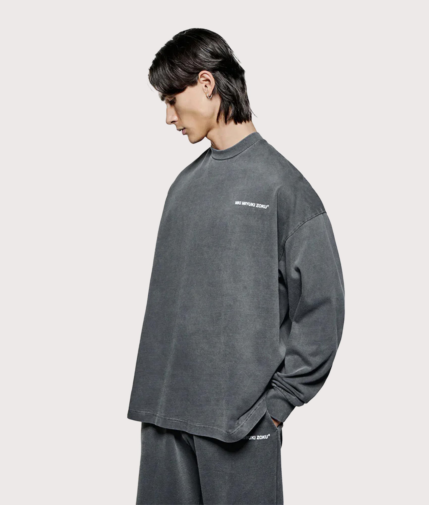 MKI Miyuki Zoku Long Sleeve Uniform T-Shirt in Pigment Black at EQVVS Menswear. Angled model front shot.