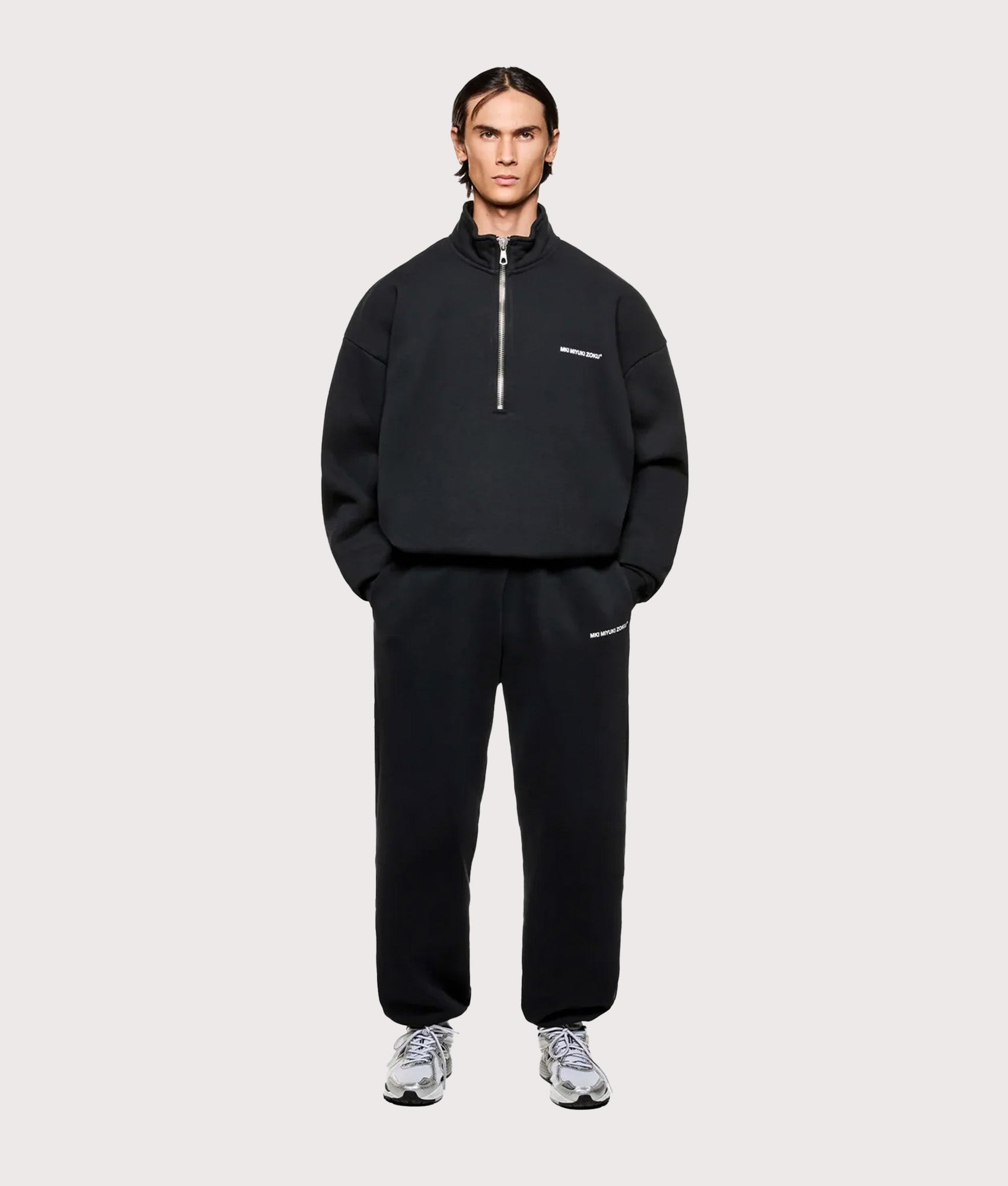 MKI MIYUKI ZOKU Oversized Fit MKI Uniform Quarter Zip in Black at EQVVS Menswear.Model full front shot.