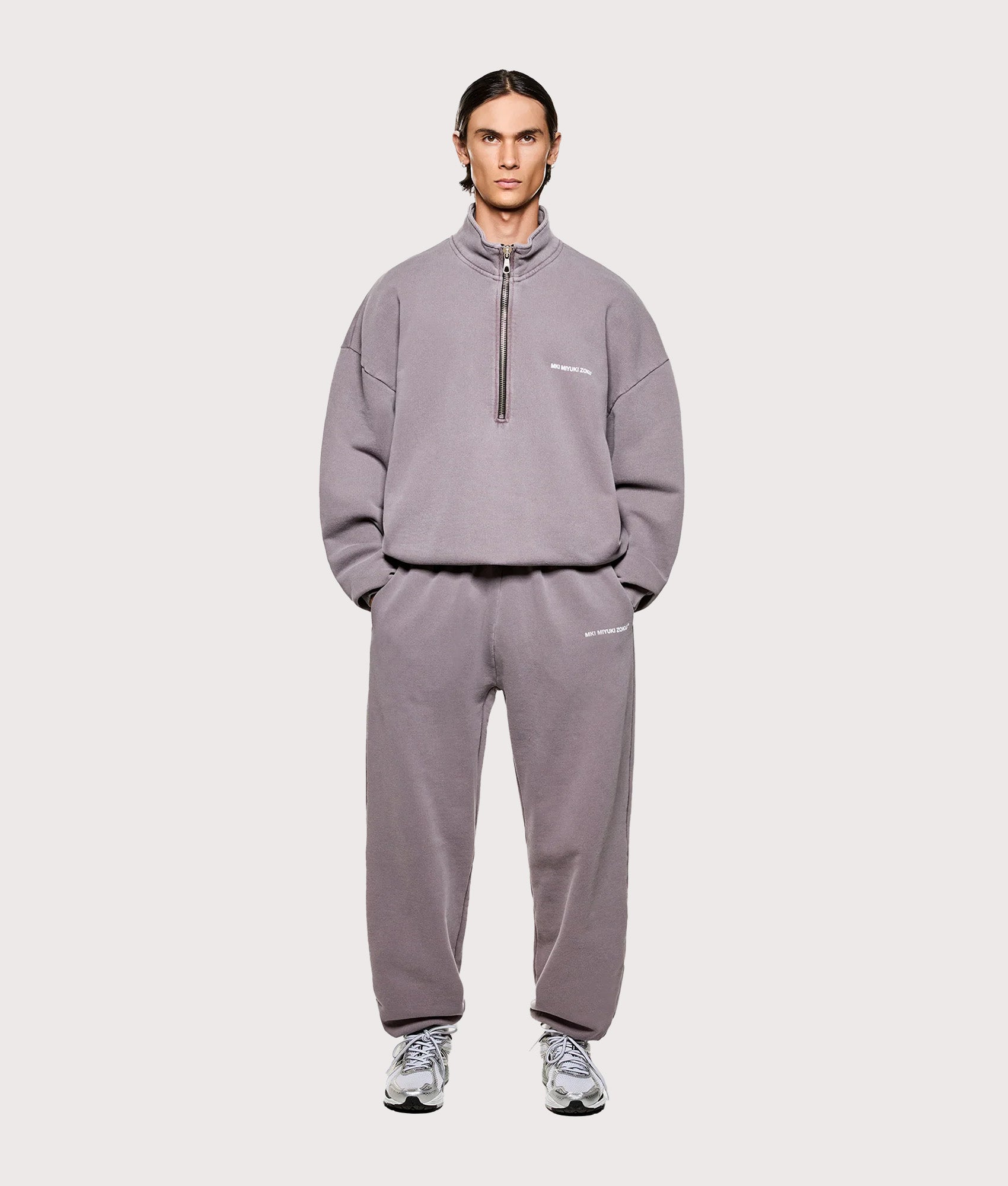 MKI MIYUKI ZOKU Oversized Fit MKI Uniform Quarter Zip in Pigment Raisin at EQVVS Menswear. Model full front shot.