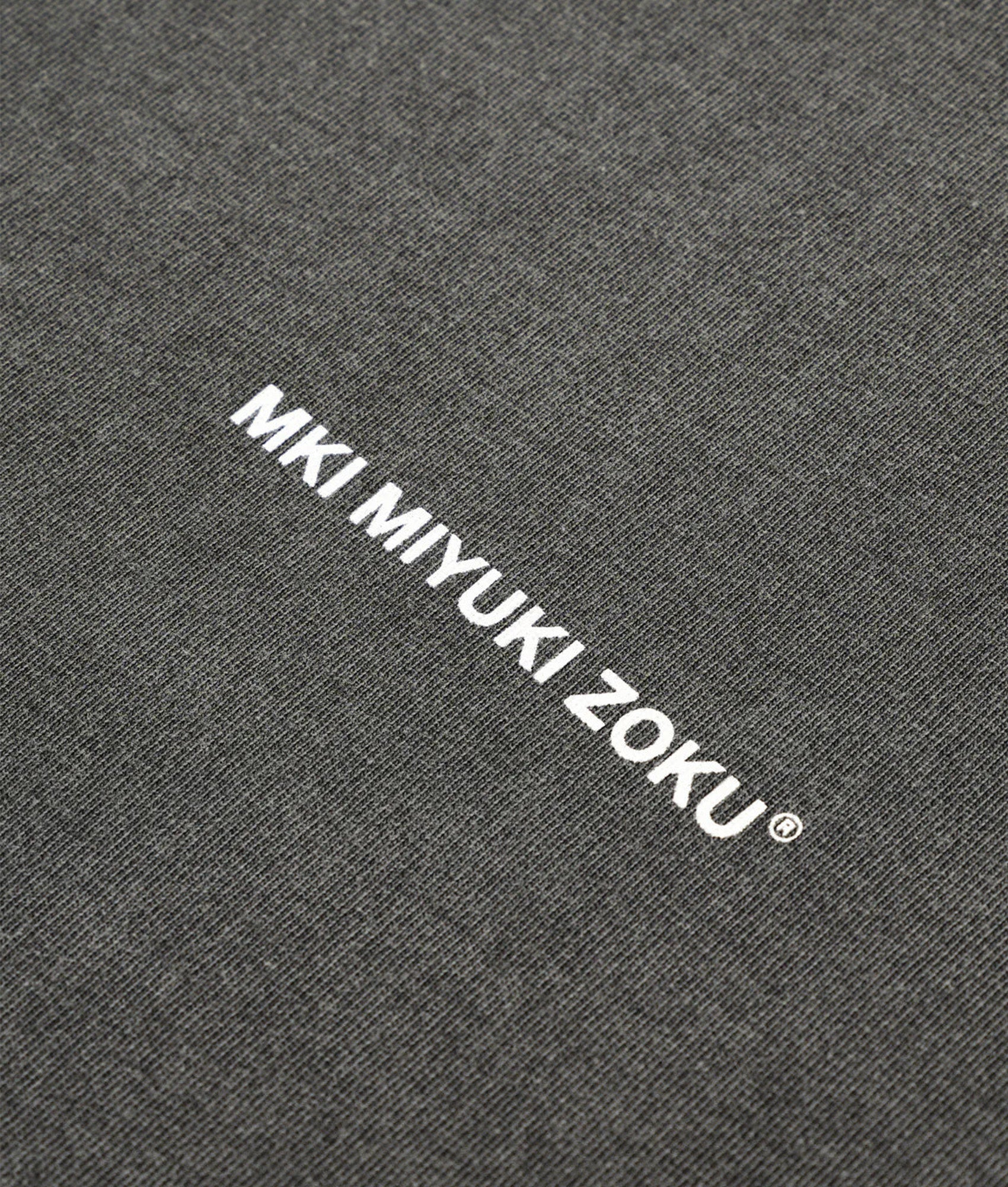 MKI MIYUKI ZOKU Oversized Uniform T-Shirt in Pigment Black at EQVVS Menswear. Detail shot.
