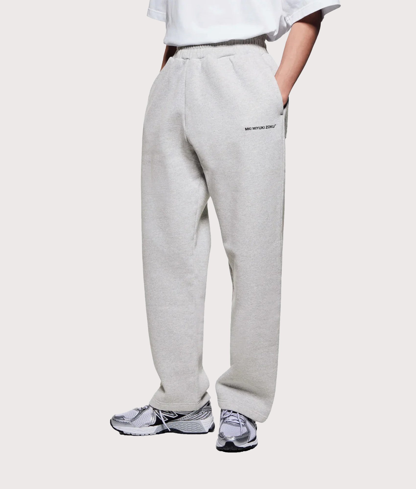 MKI MIYUKI ZOKU Uniform Wide Leg Joggers in grey at EQVVS Menswear. Angled model front shot.