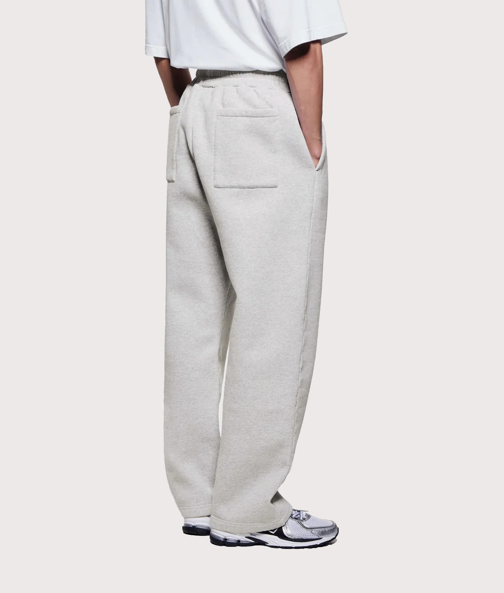 MKI MIYUKI ZOKU Uniform Wide Leg Joggers in grey at EQVVS Menswear. Angled model back shot.