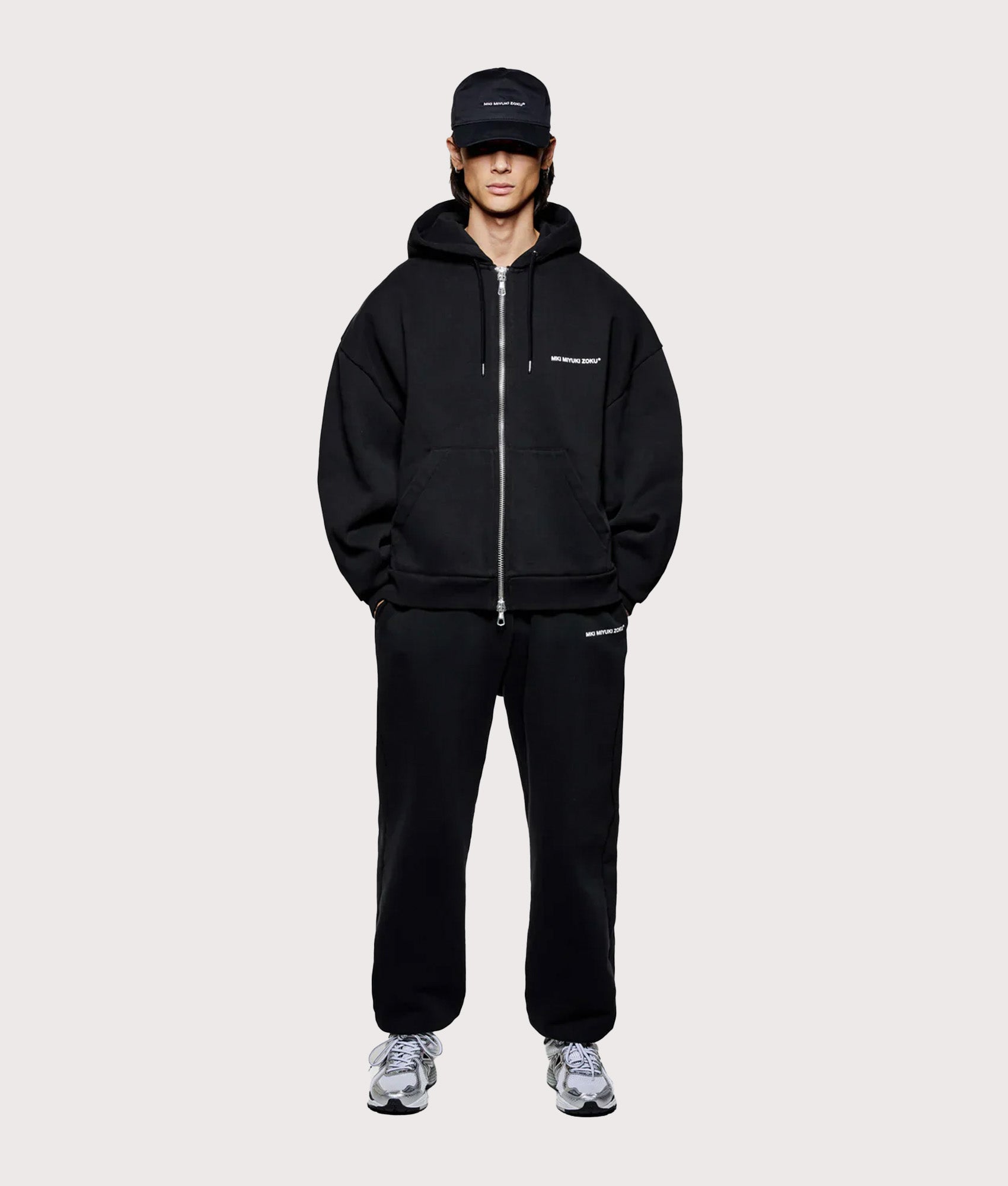 MKI MIYUKI ZOKU Oversized Uniform zip through hoodie in Black at EQVVS Menswear. Model full front shot.