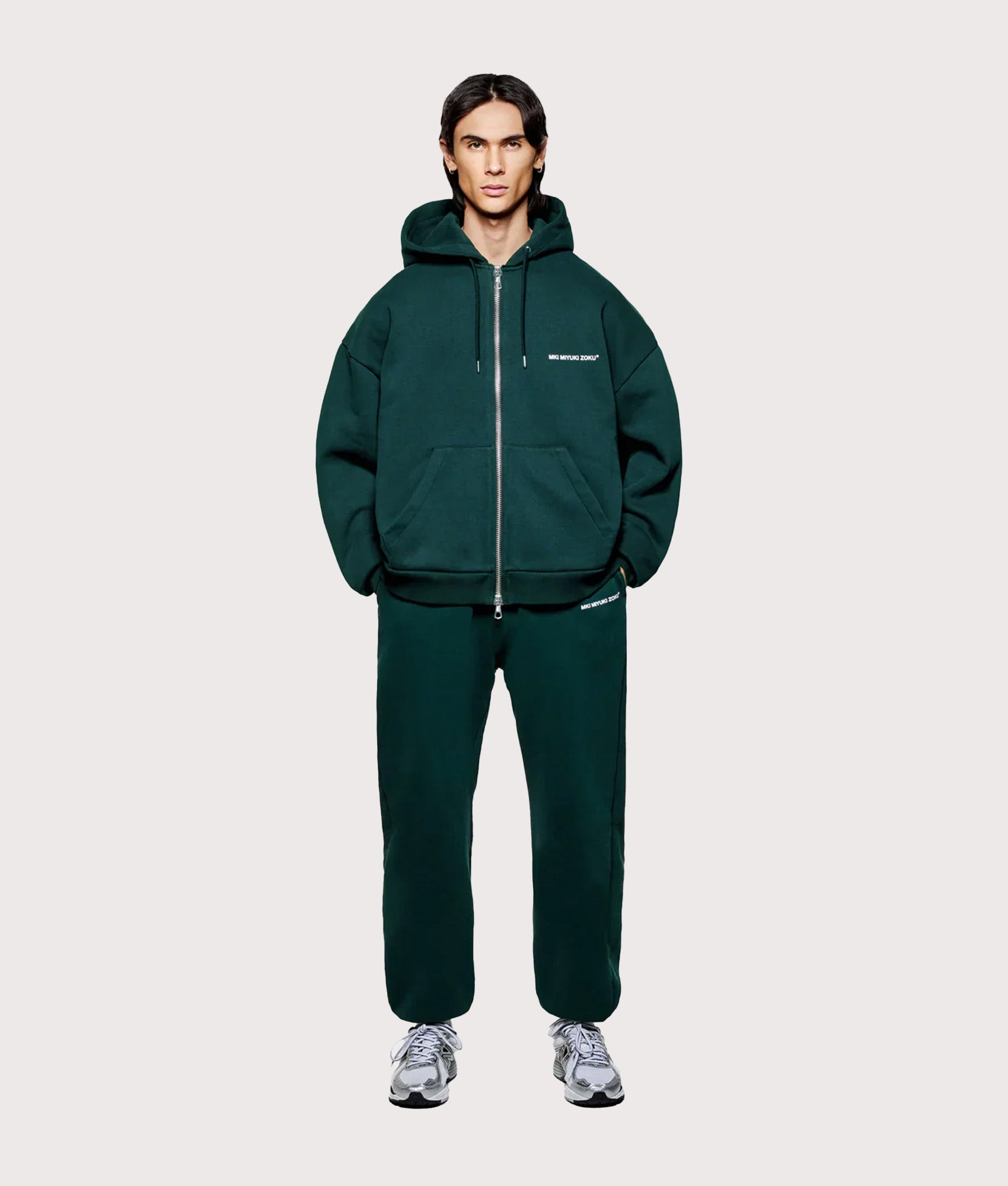 MKI MIYUKI ZOKU Oversized Uniform Zip Through Hoodie in Green at EQVVS Menswear. Model full front shot.