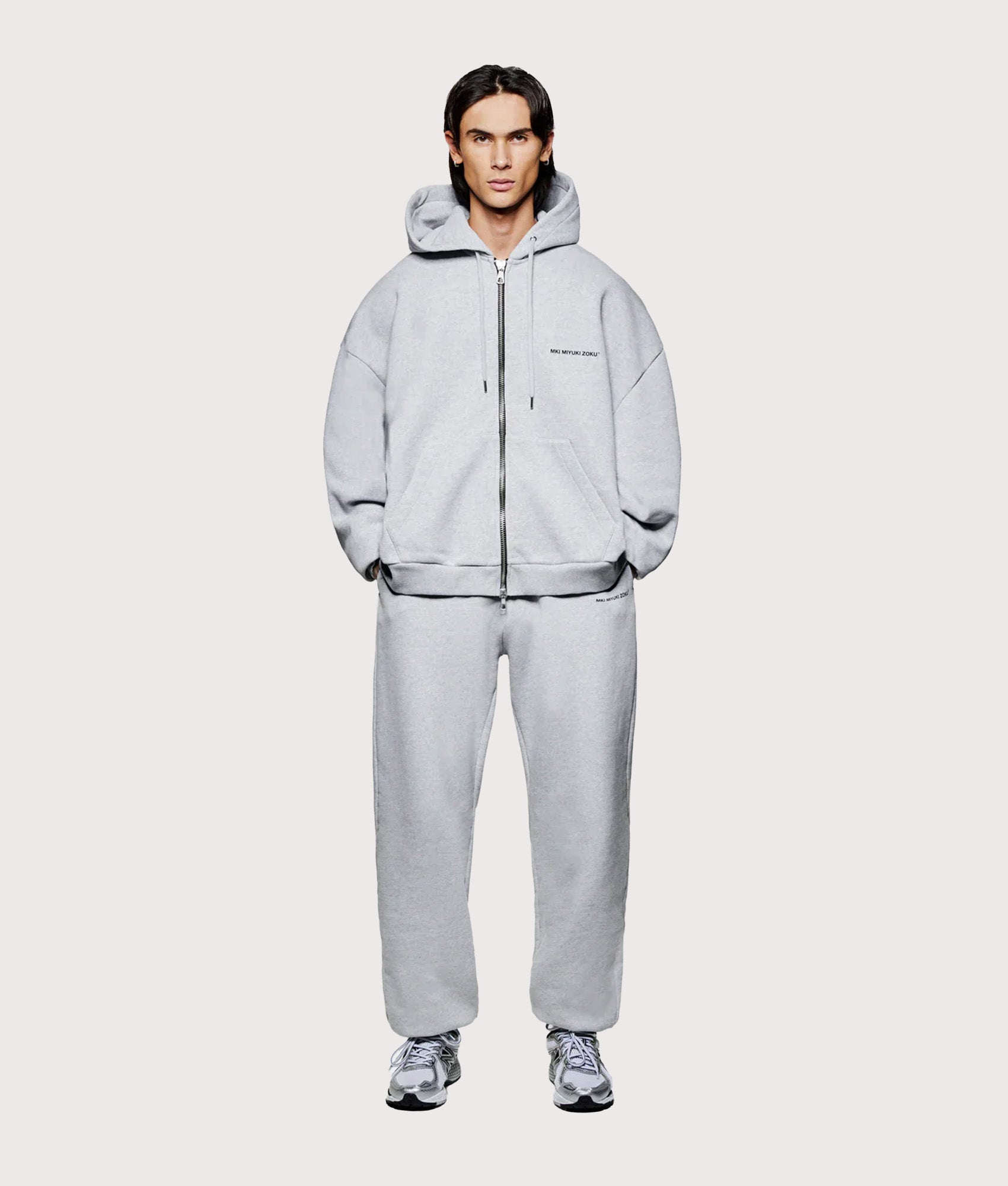 MKI MIYUKI ZOKU Oversized Uniform zip through hoodie in Grey at EQVVS Menswear. Model full front shot.