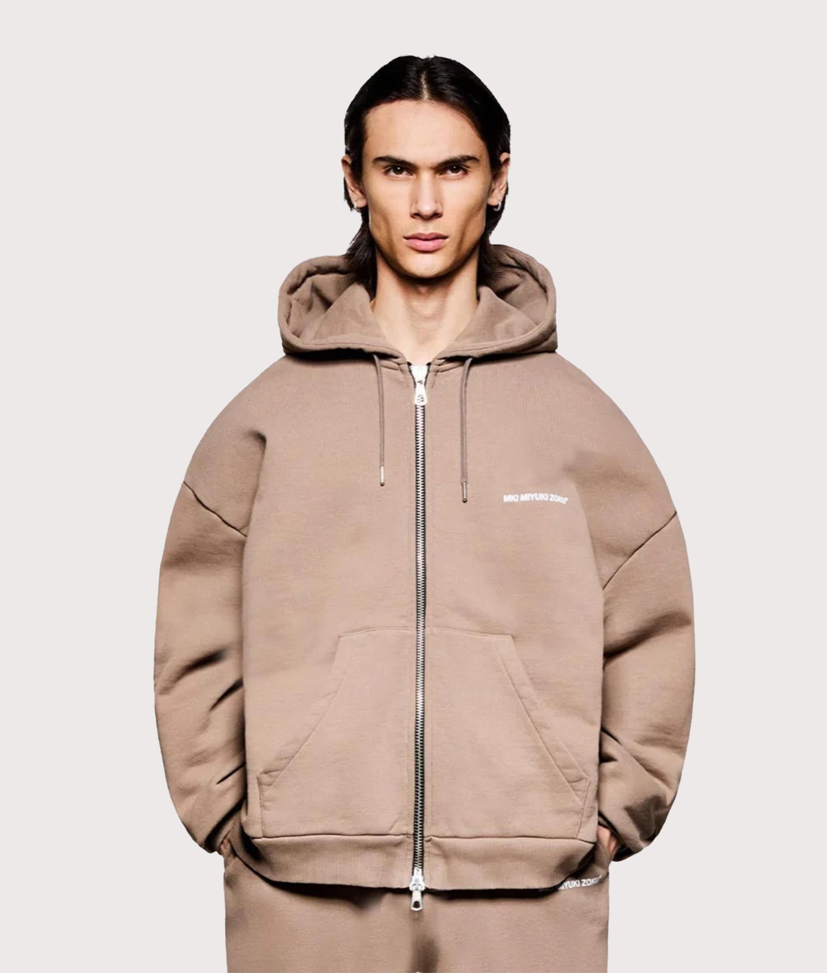 MKI MIYUKI ZOKU Oversized Uniform Zip Hoodie in Mushroom at EQVVS Menswear. Model front shot.