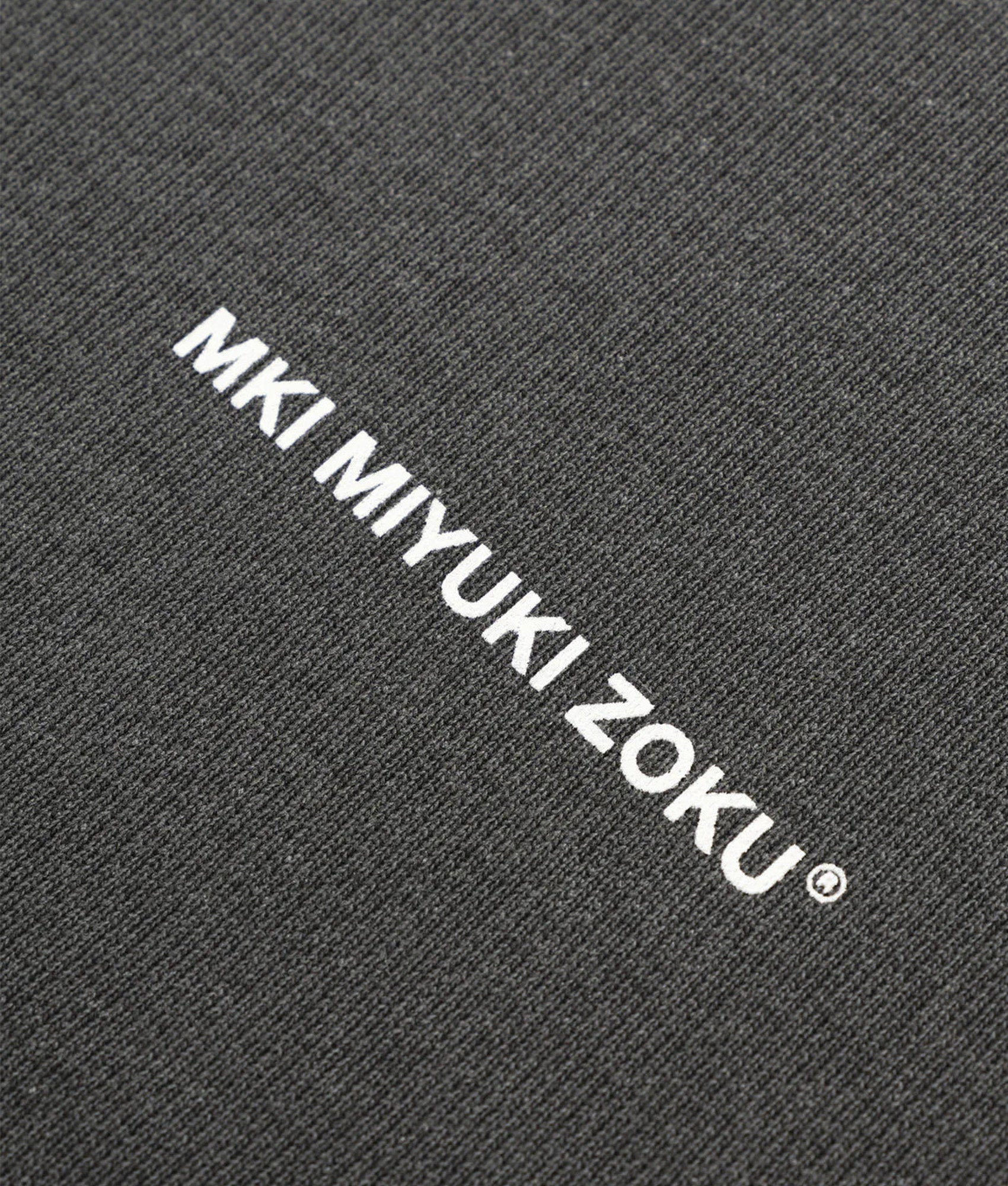 MKI MIYUKI ZOKU Oversized Uniform Zip Through Hoodie in Pigment Black at EQVVS Menswear. Detail shot.