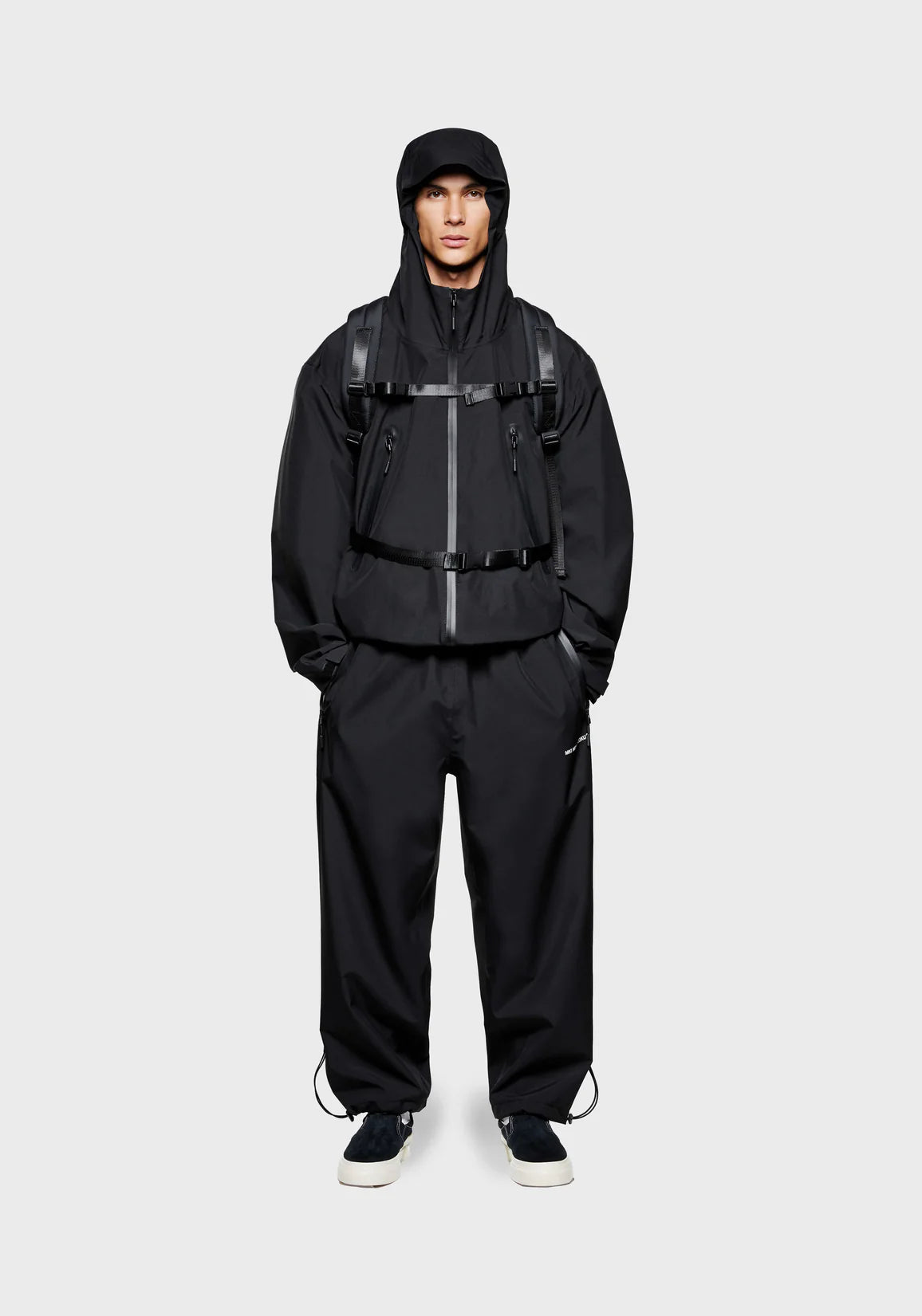 MKI MIYUKI ZOKU Relaxed Fit V2 Shell Hooded Jacket in Black at EQVVS Menswear. Front Model Shot.