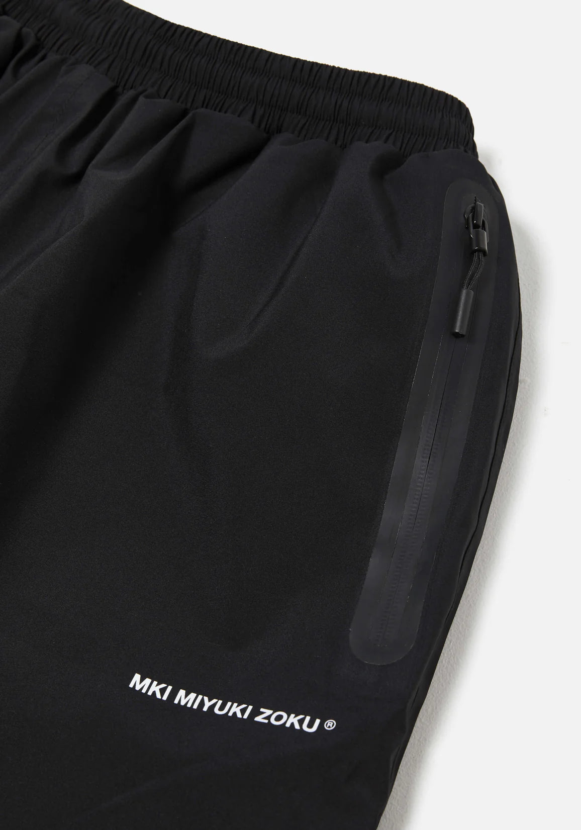 Loose Fit V2 Shell Track Pants in Black by MKI MIYUKI ZOKU at EQVVS. Detail Shot. 