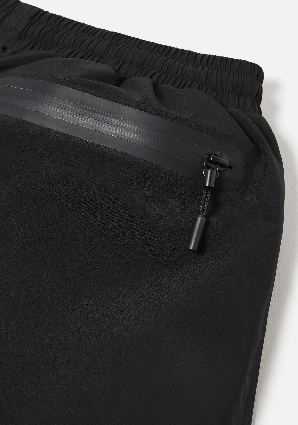 Loose Fit V2 Shell Track Pants in Black by MKI MIYUKI ZOKU at EQVVS. Detail Shot. 