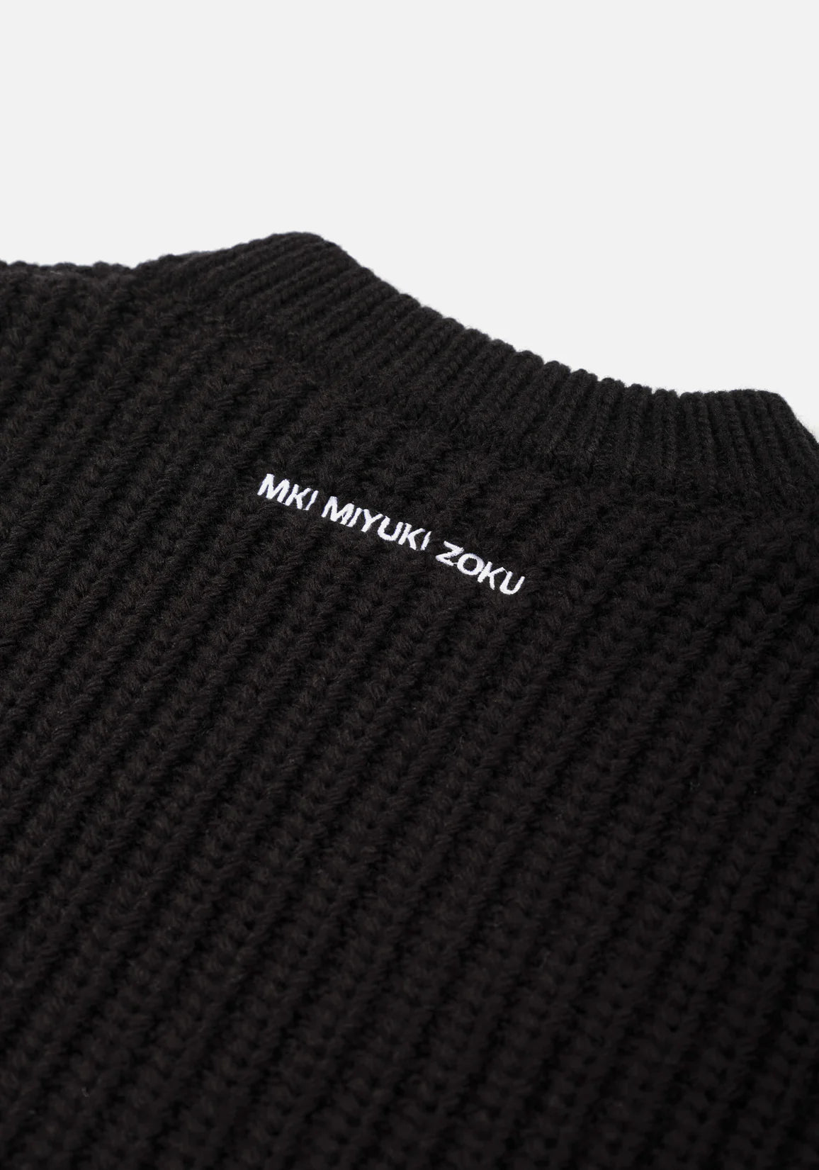 MKI Miyuki Zoku Chunky Rib Knit Crewneck Jumper in Black. Embroidery Shot.