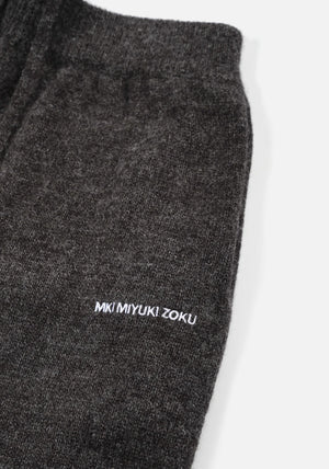 Mohair Blend Knit Wide Leg Joggers in Charcoal by MKI MIYUKI ZOKU at EQVVS. Detail Logo Shot. 