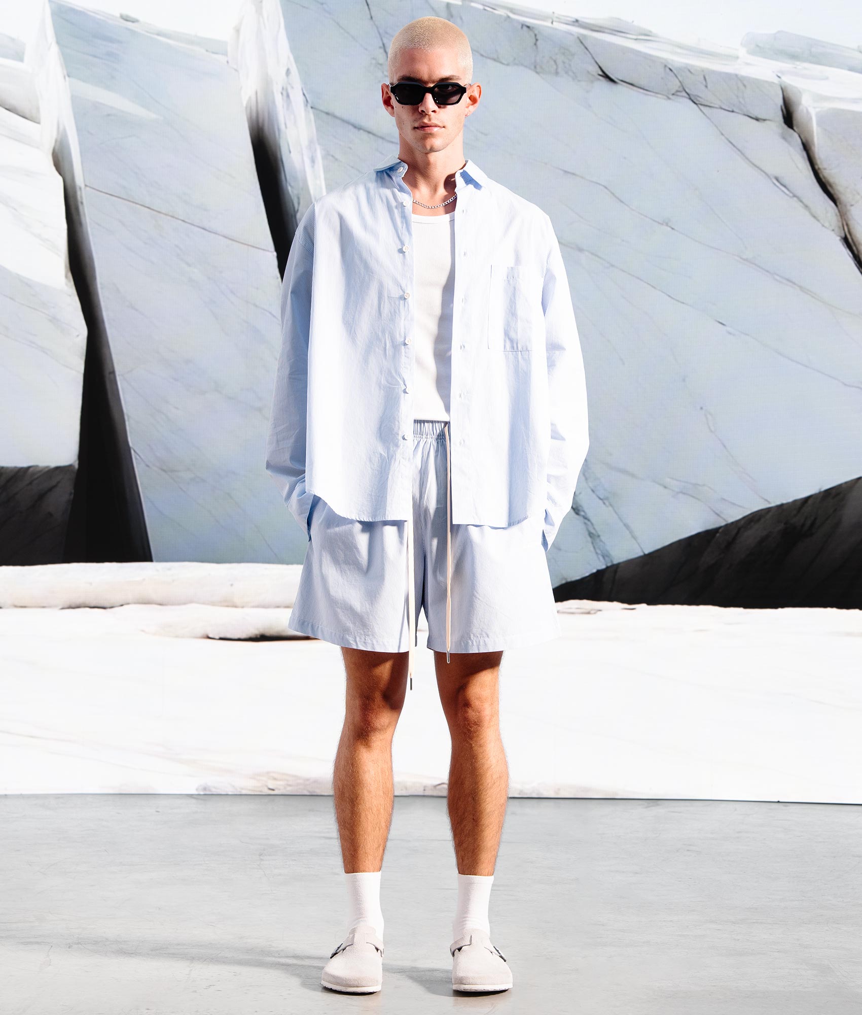 Relaxed Fit Striped Shorts in Blue by MKI MIYUKI ZOKU. EQVVS Campaign Shot. 