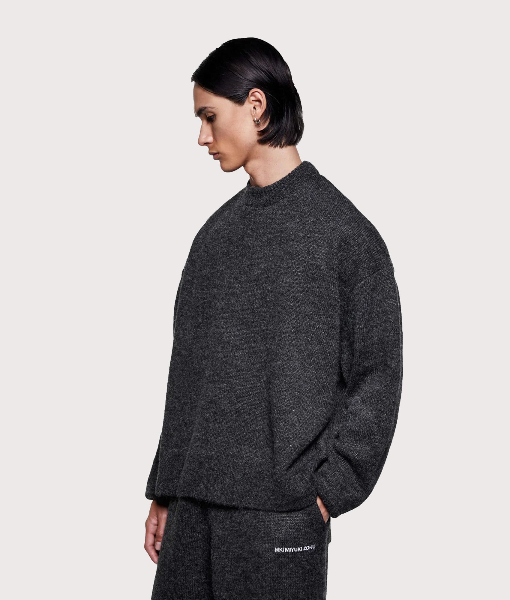 MKI MIYUKI ZOKU Mohair Blend Crewneck Jumper in Charcoal at EQVVS Menswear. Angled model front shot.