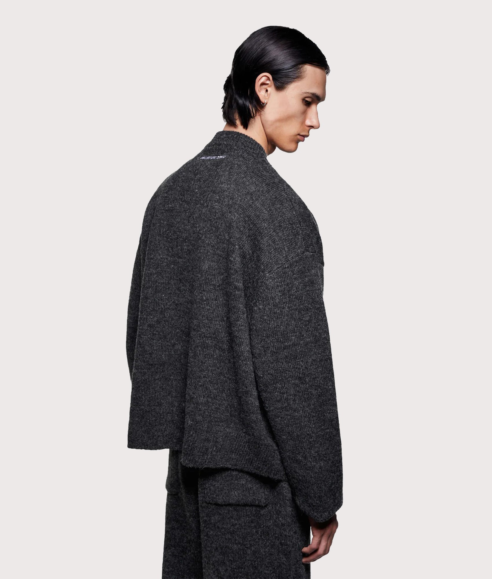MKI MIYUKI ZOKU Mohair Blend Crewneck Jumper in Charcoal at EQVVS Menswear. Angled model back shot.