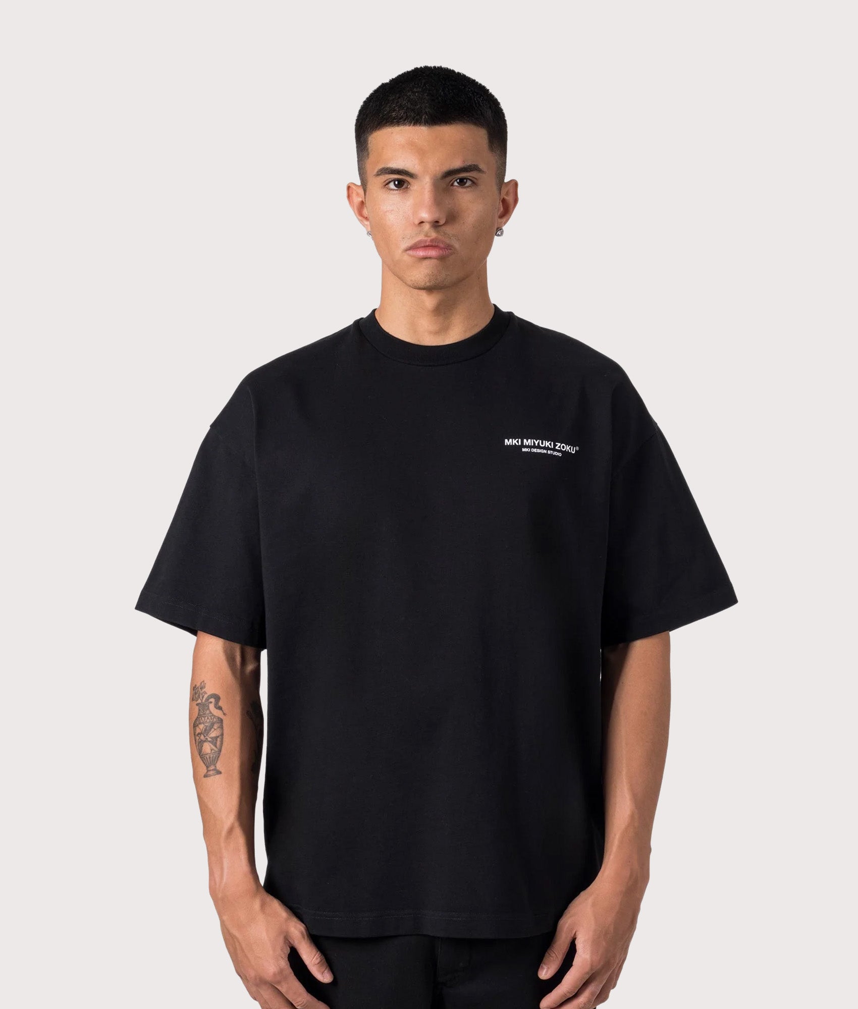 MKI MIYUKI ZOKU Oversized Fit Design Studio T-Shirt in Black at EQVVS Menswear. Model front shot.