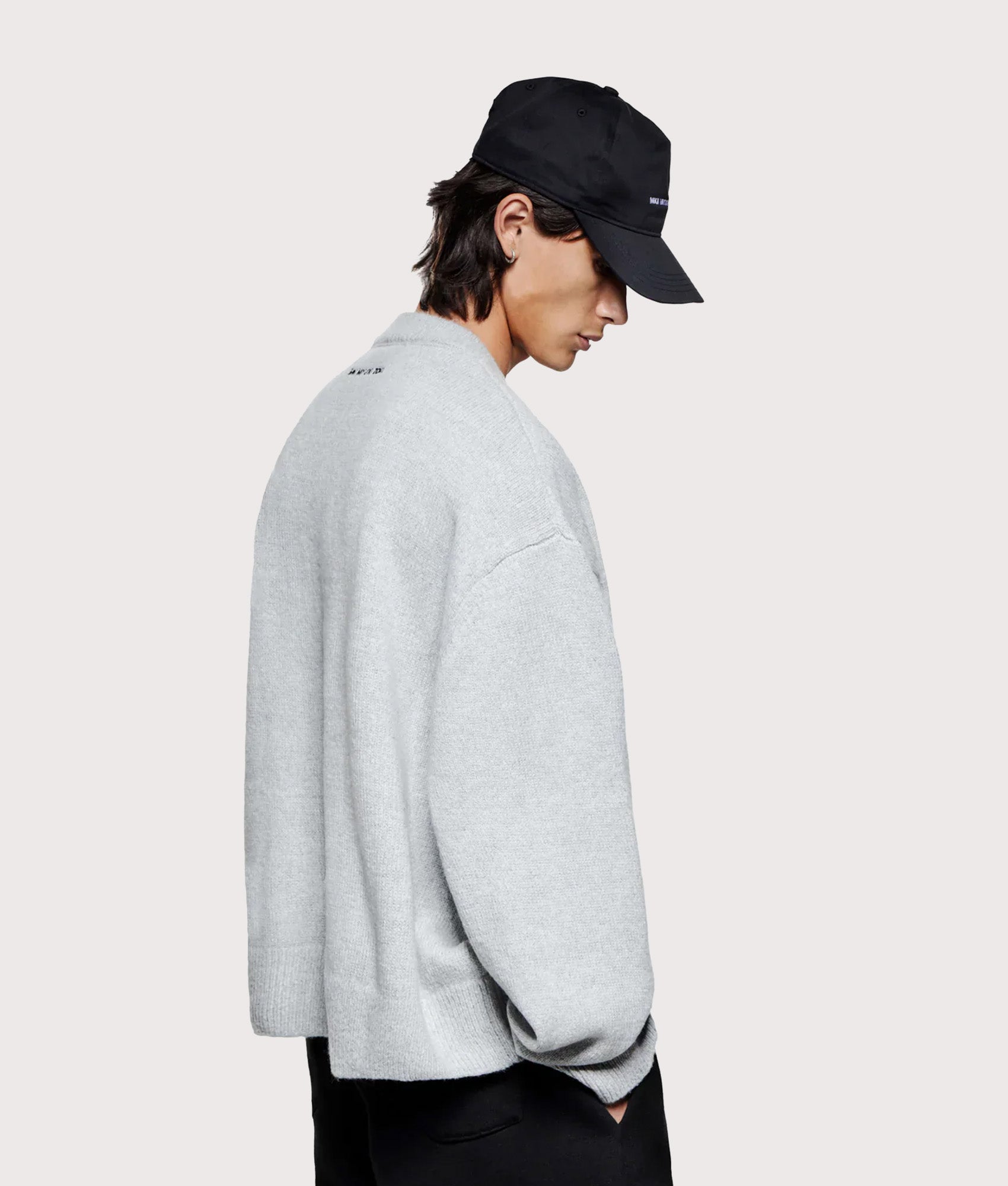 MKI Miyuki Zoku Oversized Mohair Blend Knit Crew Jumper in Light Grey at EQVVS Menswear. Angled model back shot.