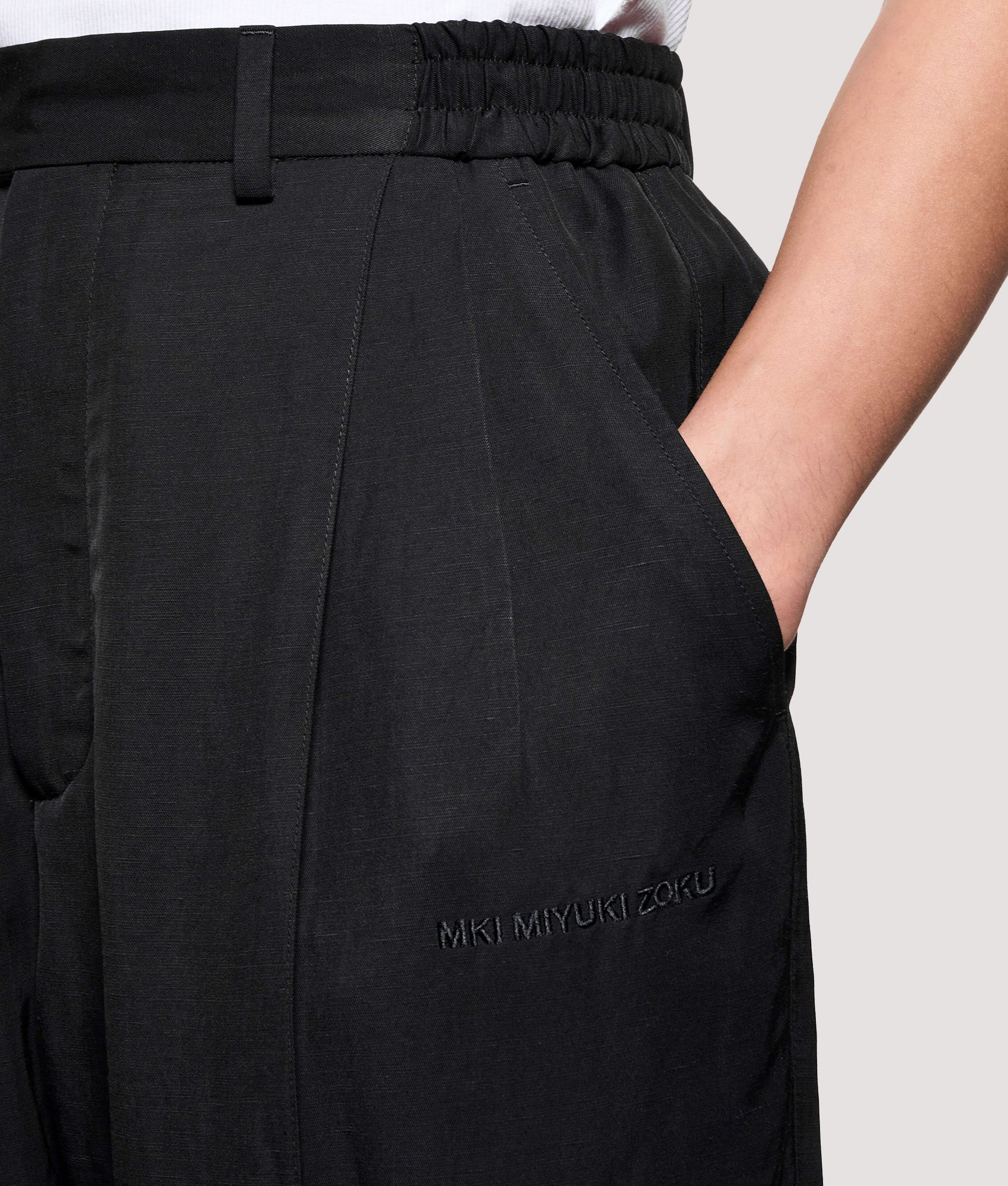 MKI MIYUKI ZOKU Pleated Suit Pants in Black at EQVVS Menswear. Detail shot.