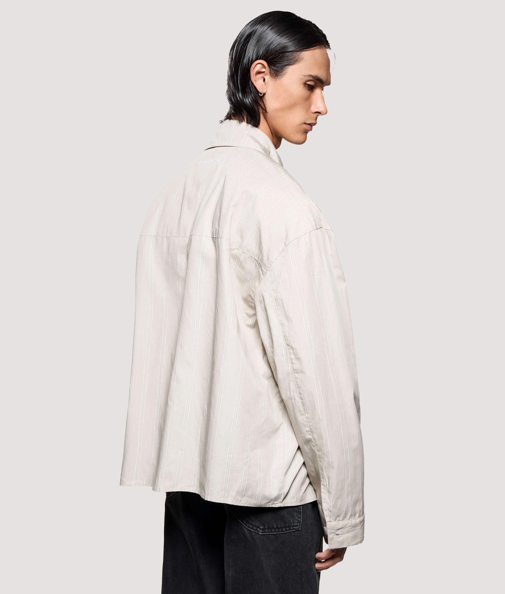 MKI MIYUKI ZOKU Box Fit Poplin Stripe Dress Shirt in Light Sage at EQVVS Menswear. Angled model back shot.
