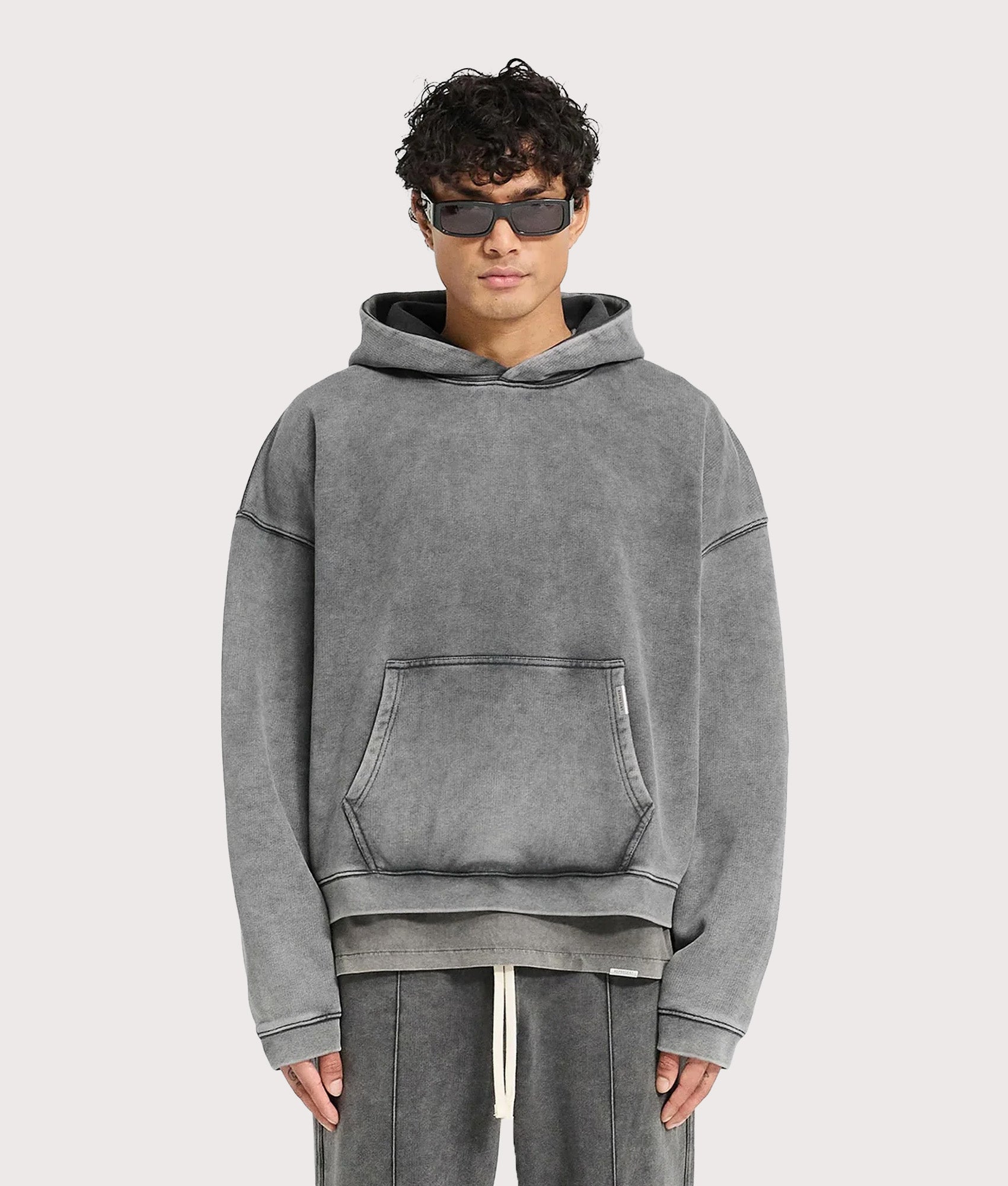 REPRESENT Initial Boxy Hoodie in Vintage Grey at EQVVS Menswear. Model front shot.