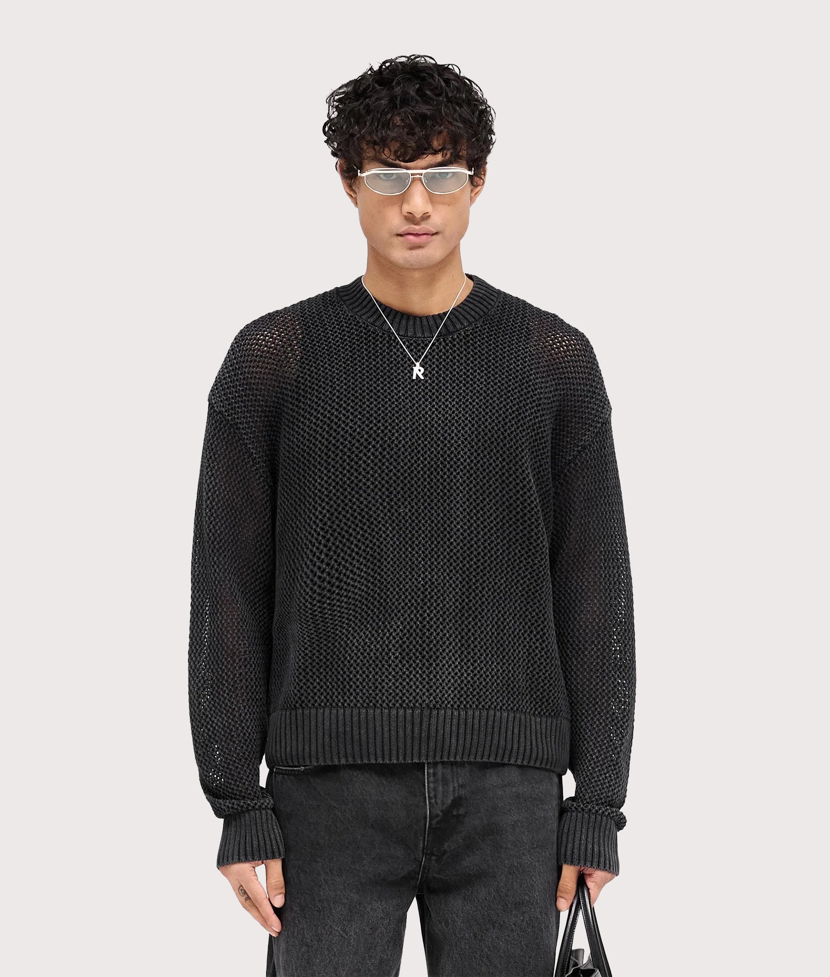REPRESENT Open Gauge Knit Jumper in Jet Black. Model front shot.