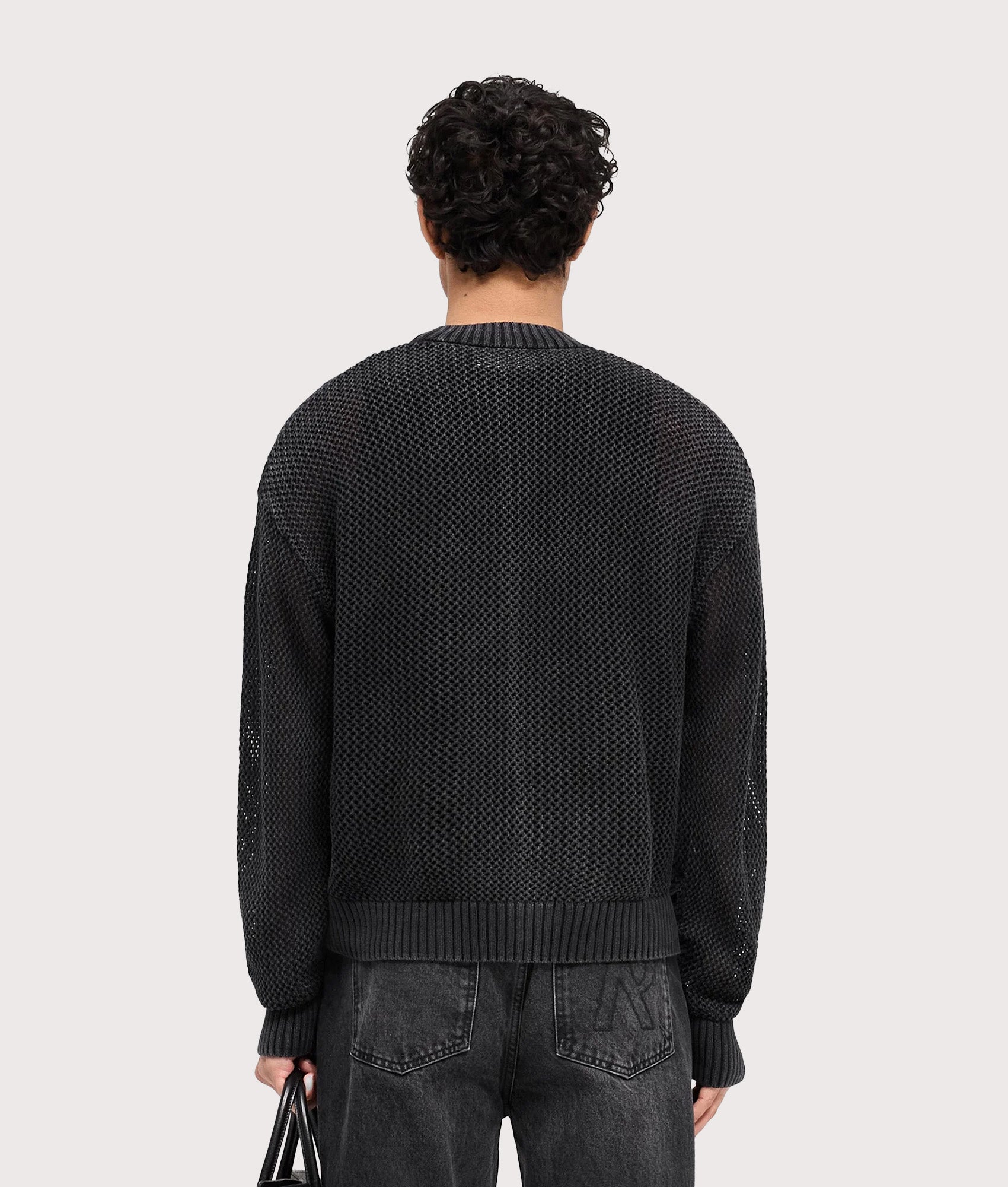 REPRESENT Open Gauge Knit Jumper in Jet Black. Model back shot.