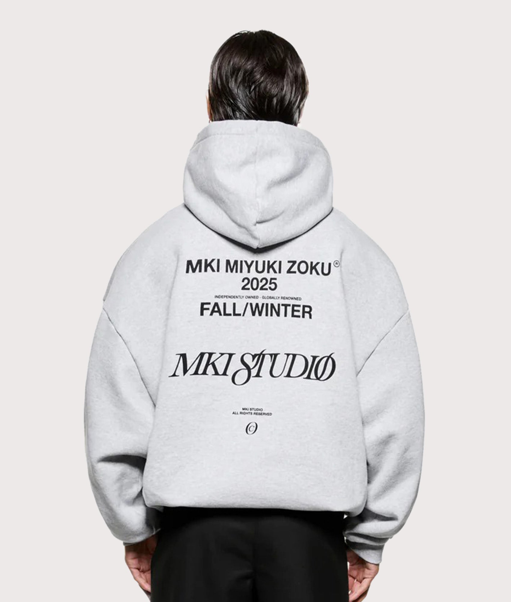 MKI MIYUKI ZOKU Script hoodie in Grey at EQVVS Menswear. Model Back shot.