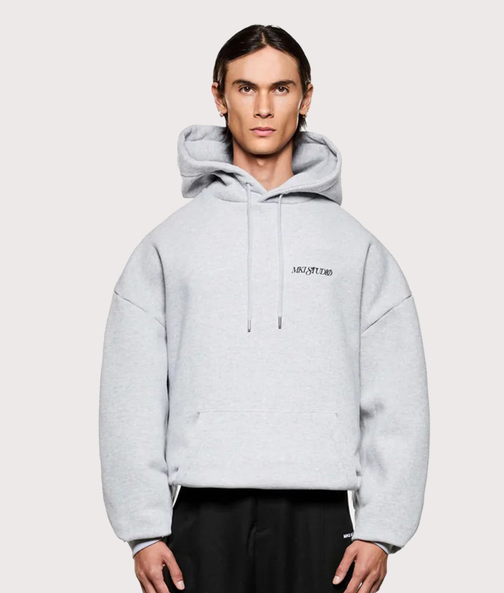 MKI MIYUKI ZOKU Script hoodie in Grey at EQVVS Menswear. Model front shot.